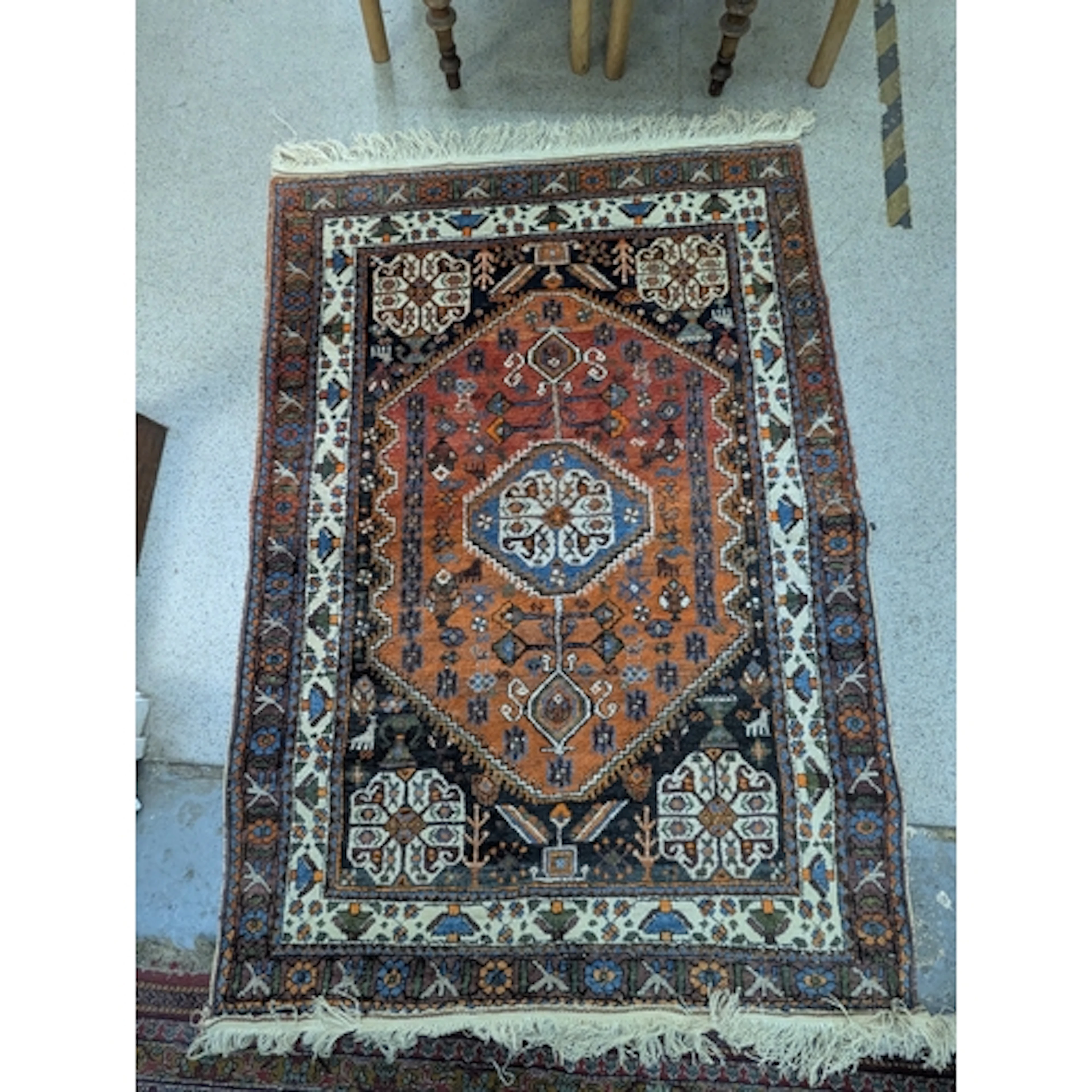 A Persian Shiraz style rug with a central medallion and geom...