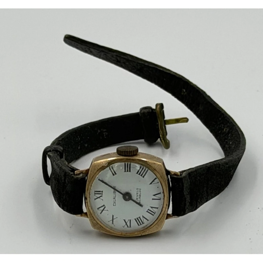 A 9ct gold ladies watch on leather strap.