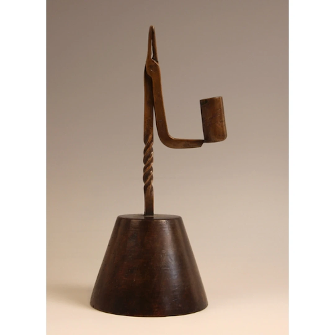 An unusual copper combination rush light and candle holder, ...