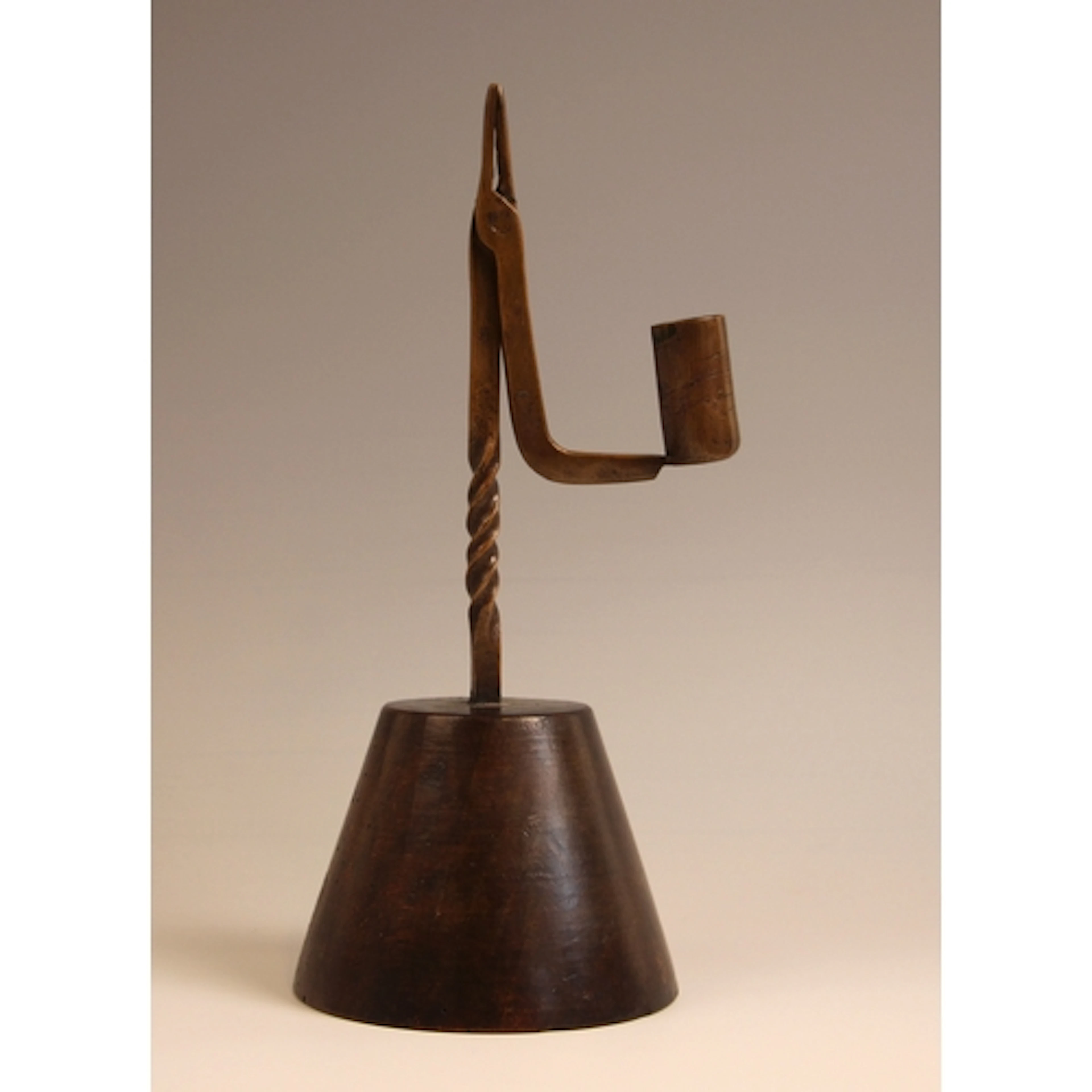 An unusual copper combination rush light and candle holder, ...