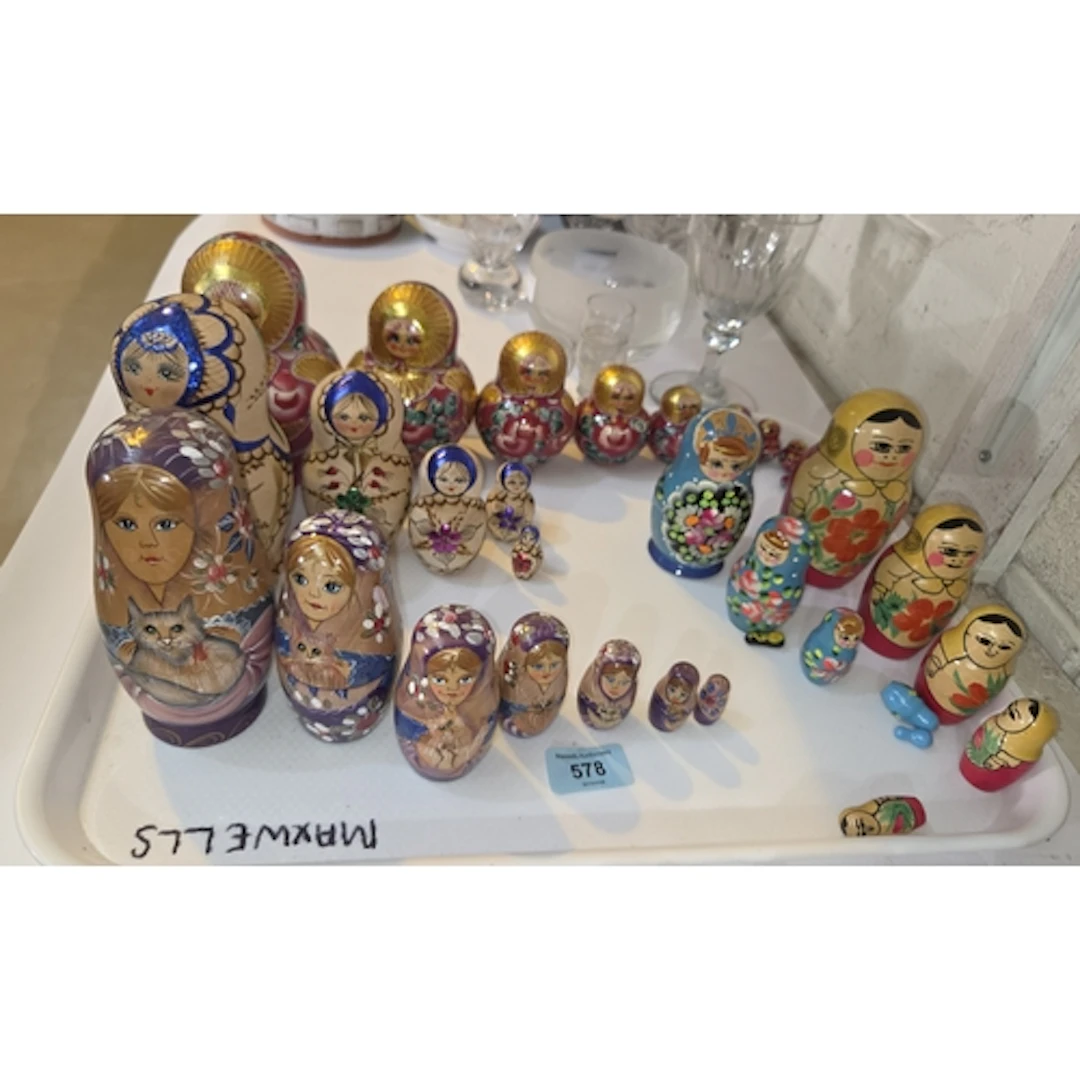 A collection of Russian Matryoshka wooden nests of dolls, on...