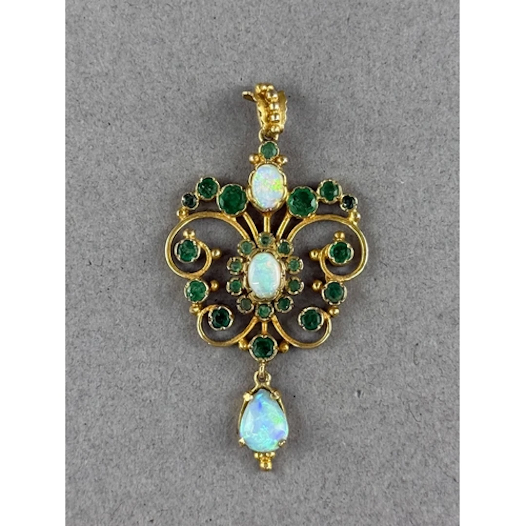 Jewellery: a 9ct yellow gold openwork pendant, two opals wit...