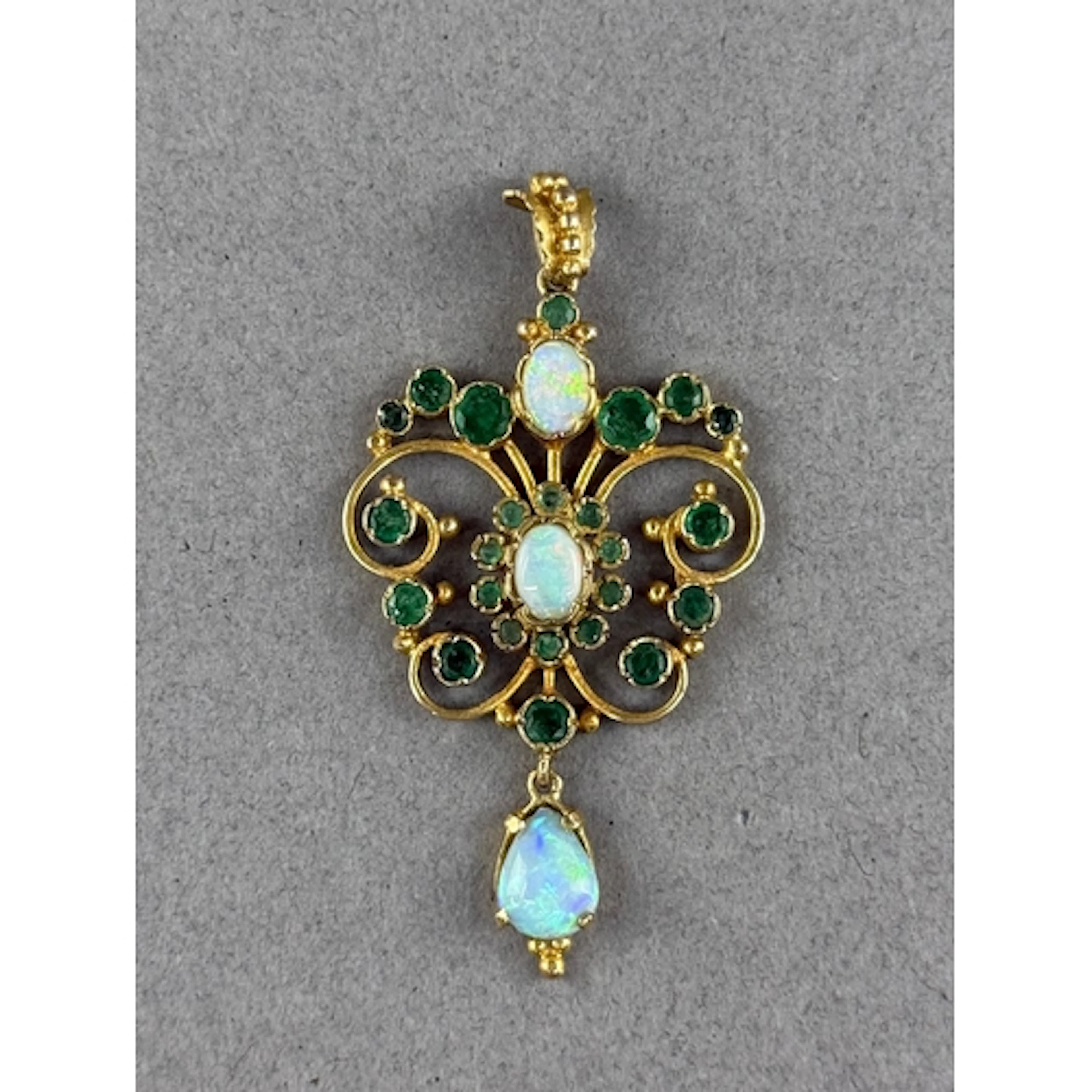 Jewellery: a 9ct yellow gold openwork pendant, two opals wit...