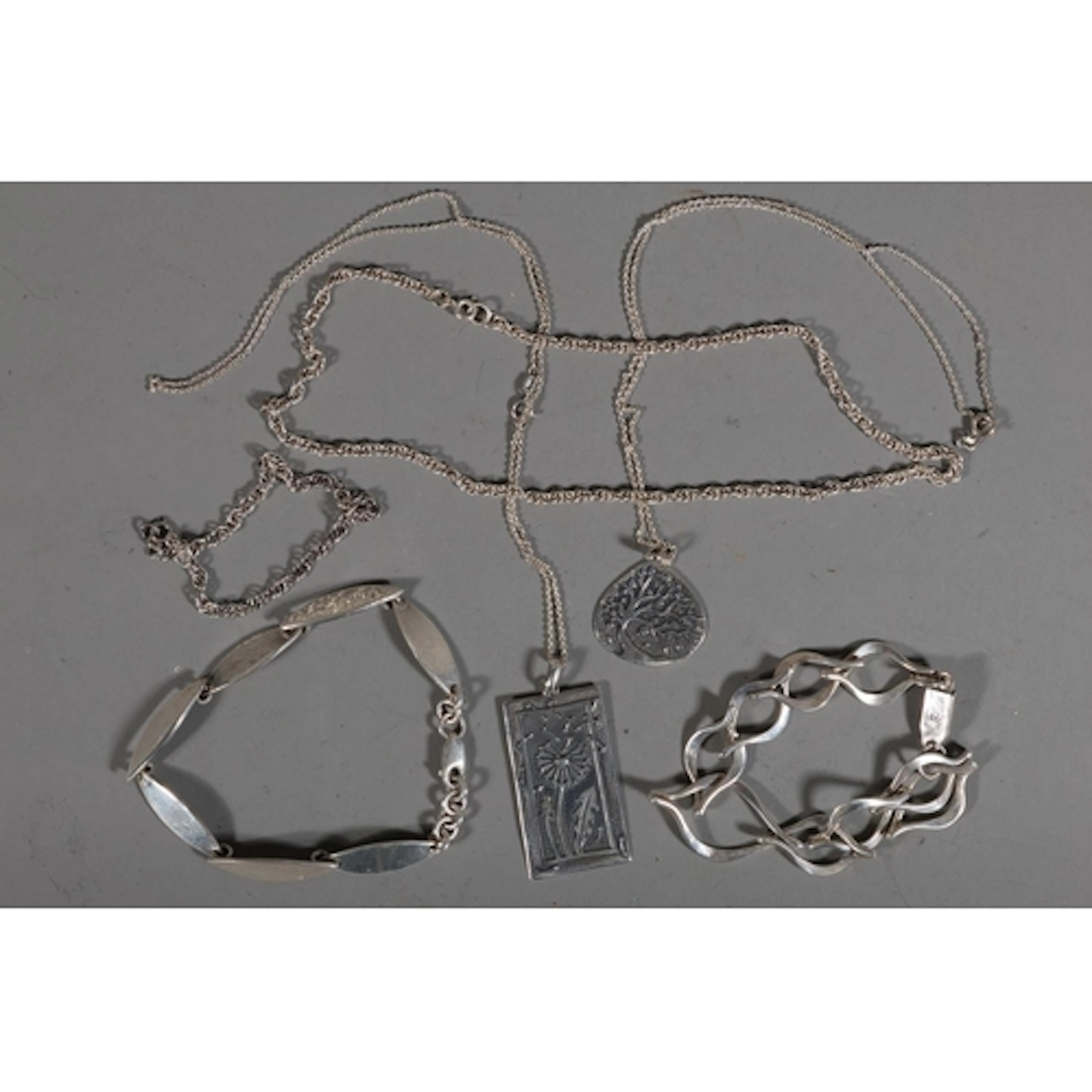 Two Mexican silver bracelets, 40g gross. Two silver pendants...