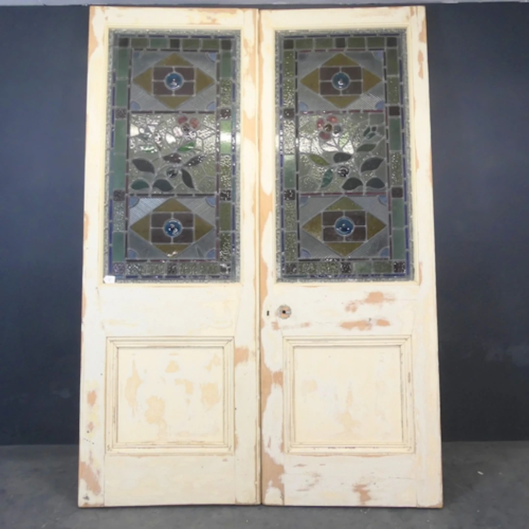 A commanding pair of panelled and painted pine interior door...
