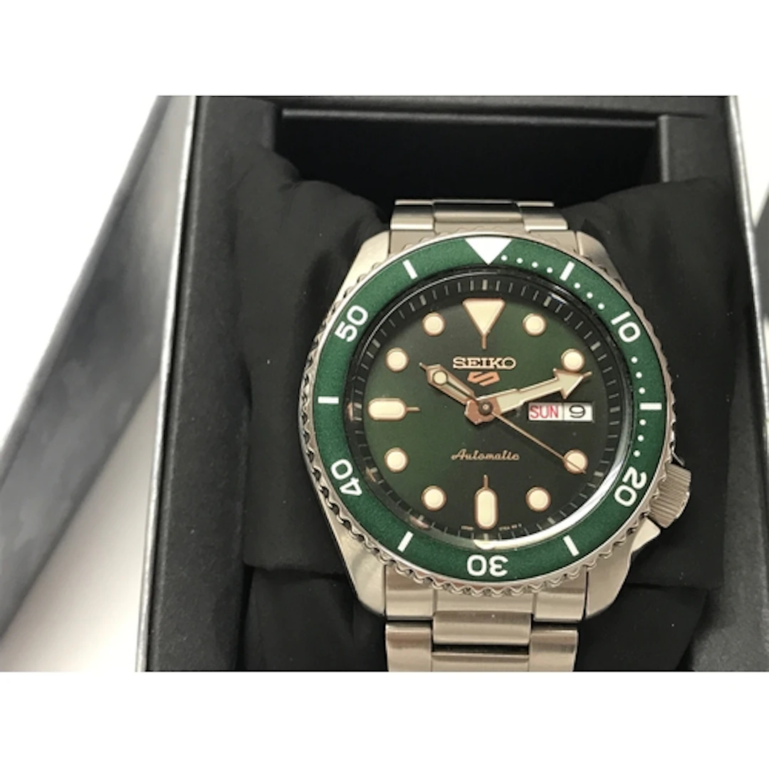 Seiko 5 Sports features a green dial and matching bezel pair...