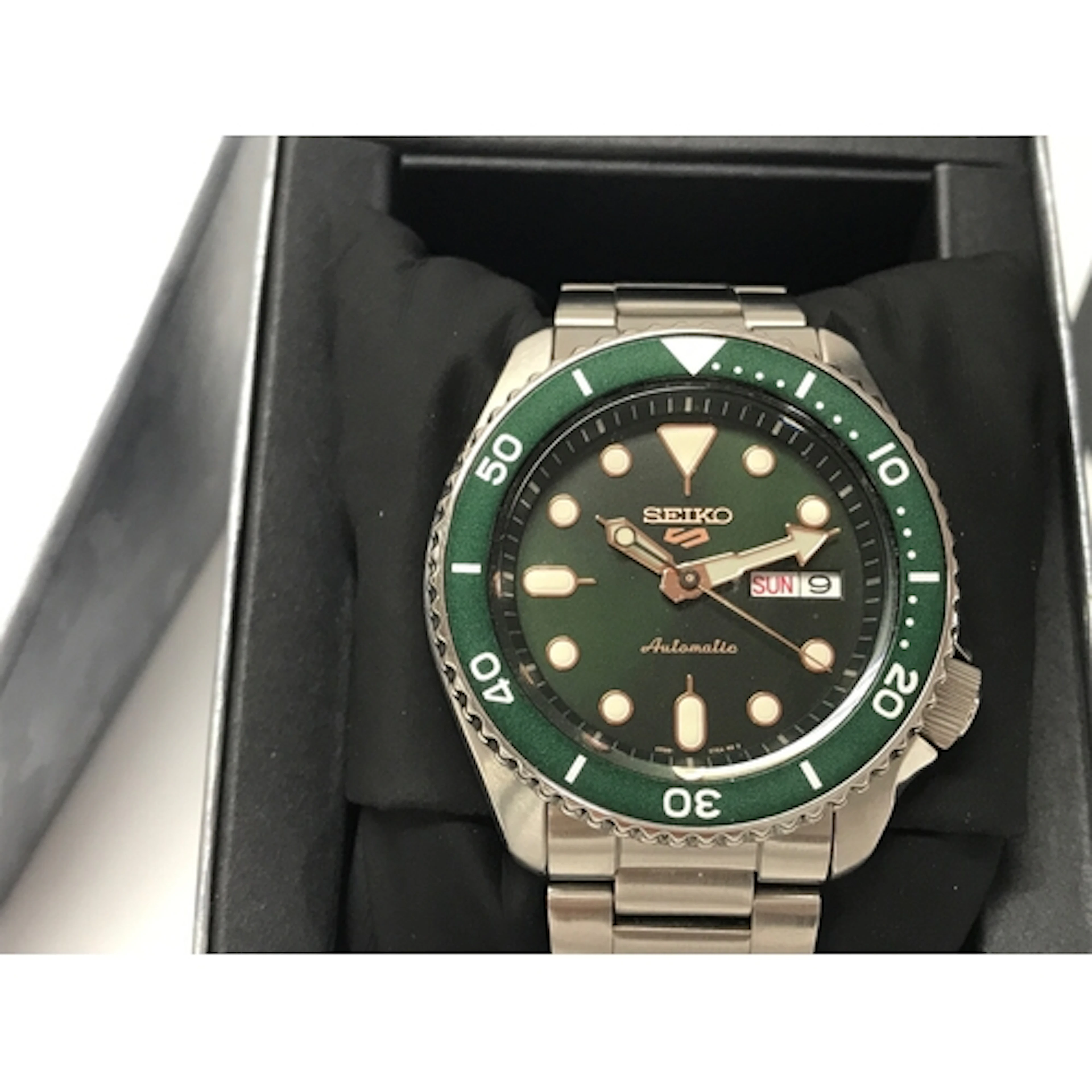 Seiko 5 Sports features a green dial and matching bezel pair...