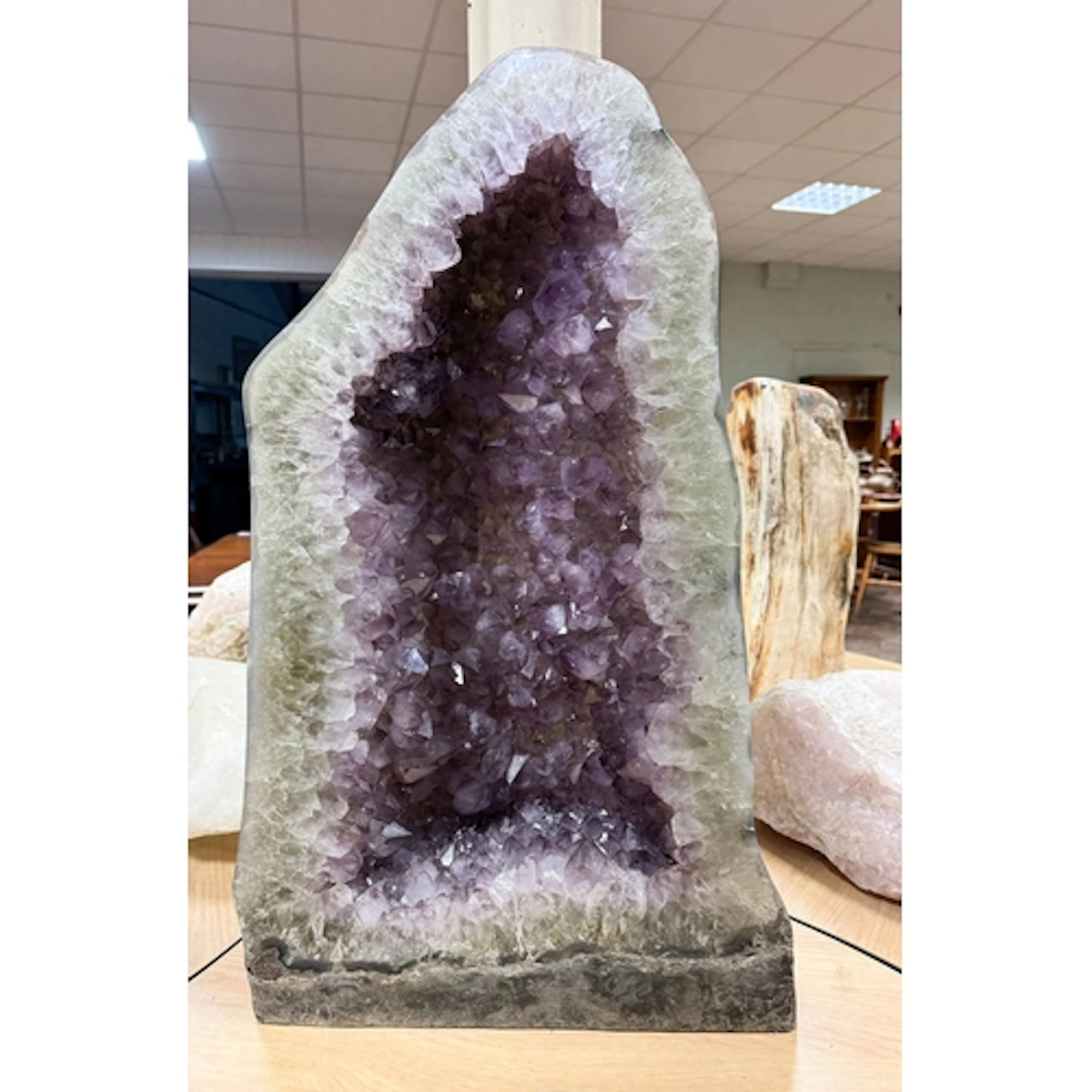 A Cathedral amethyst geode with polished back, measuring 25"...