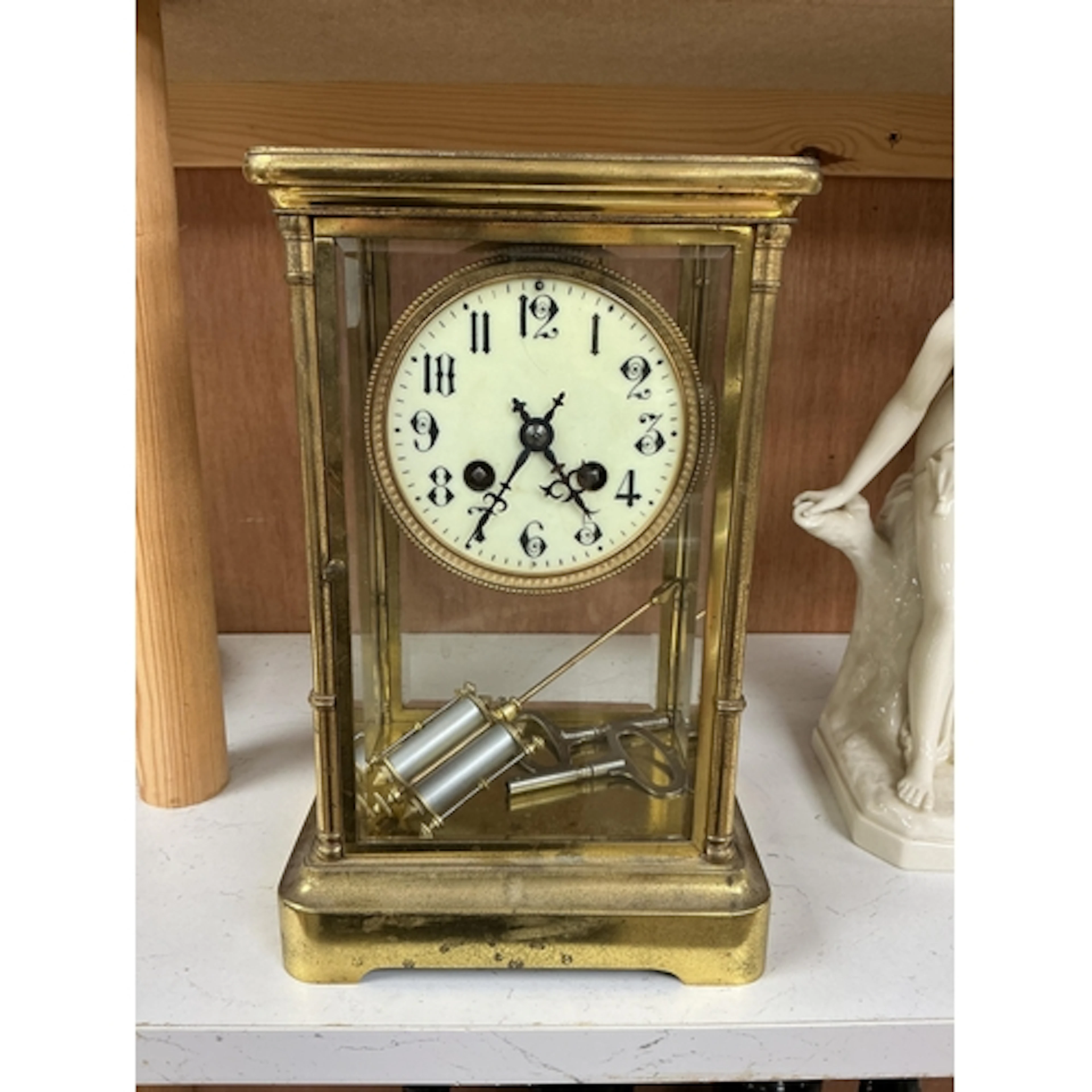 An early 20th century brass four glass mantel clock with Ara...