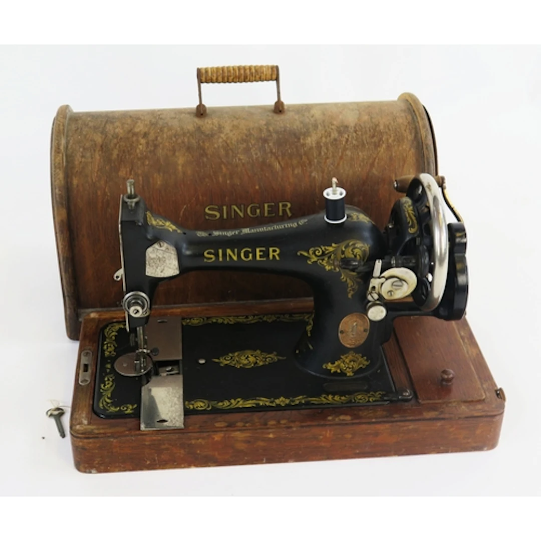 A Singer sewing machine of traditional design contained in a...