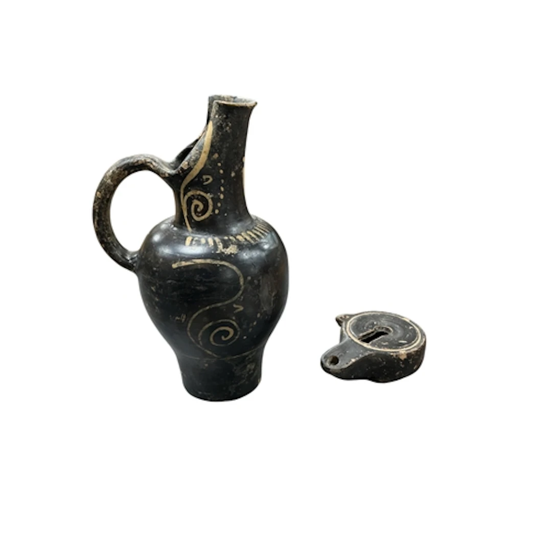A 4th century Etruscan beaked pottery jug and a Roman potter...