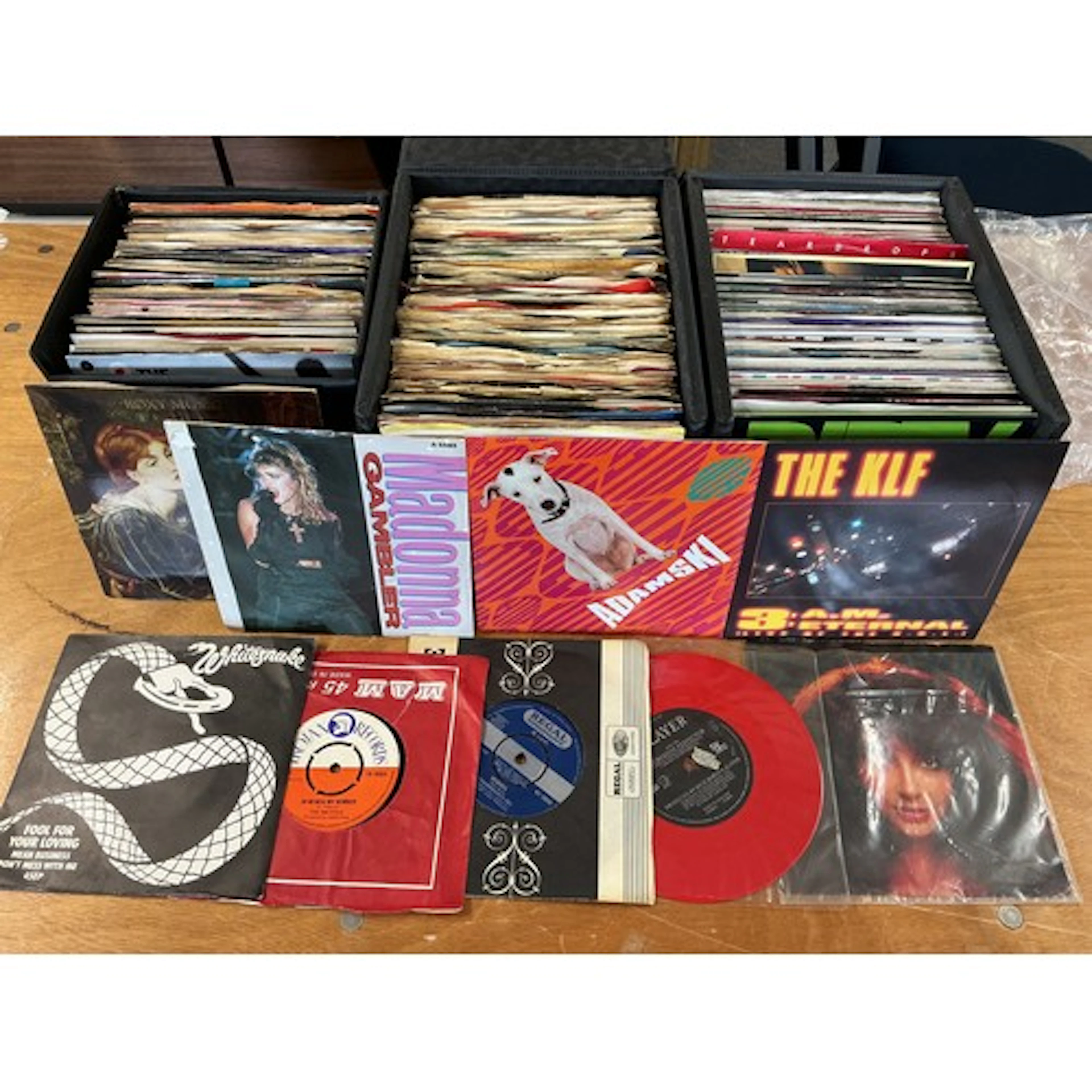 A collection of 7” singles and LPs in three record cases and...