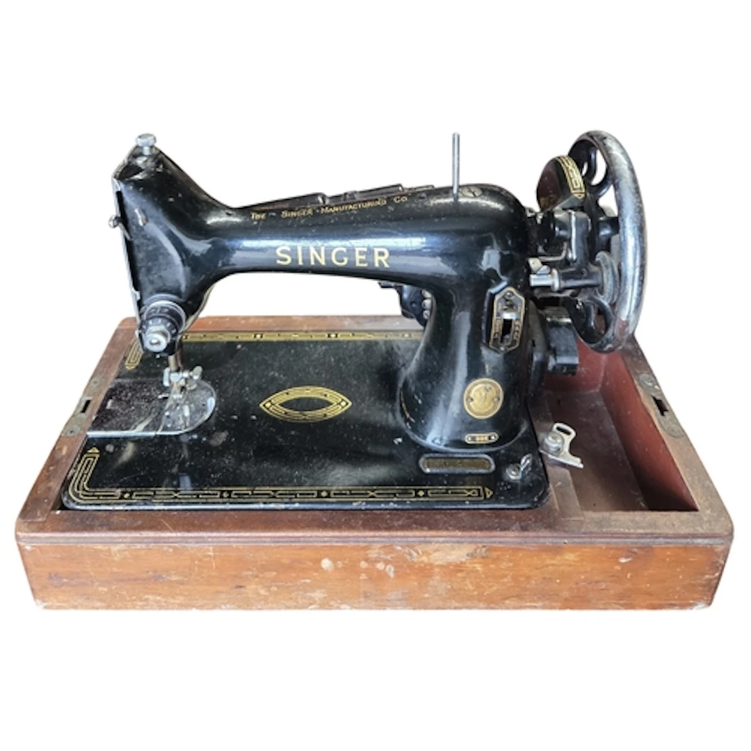 A Singer sewing Machine with pedal along with an Underwood t...
