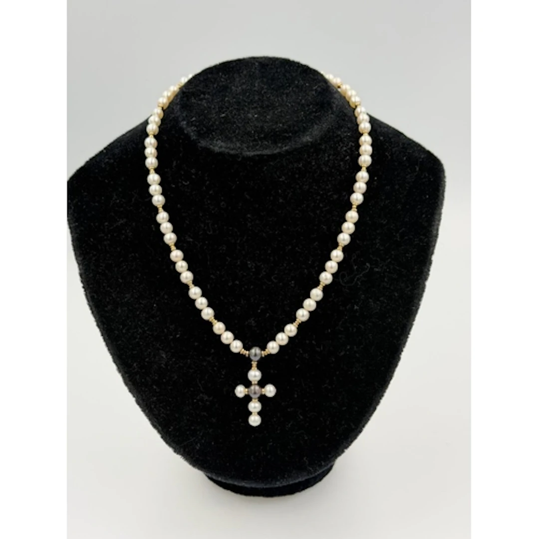 A pearl necklace with 9ct gold fastener and spacers along wi...
