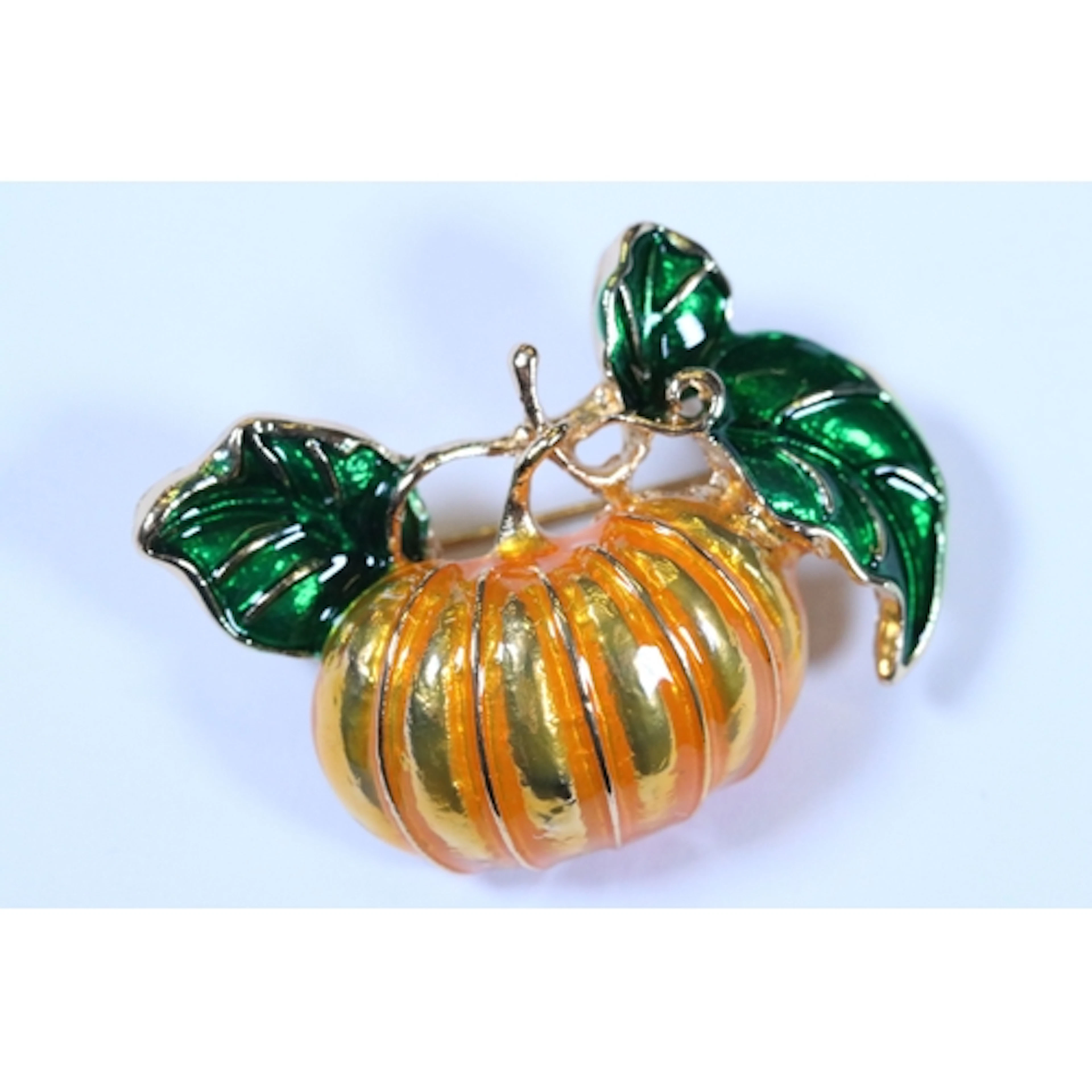 A contemporary Halloween gold tone and enamel pumpkin brooch...