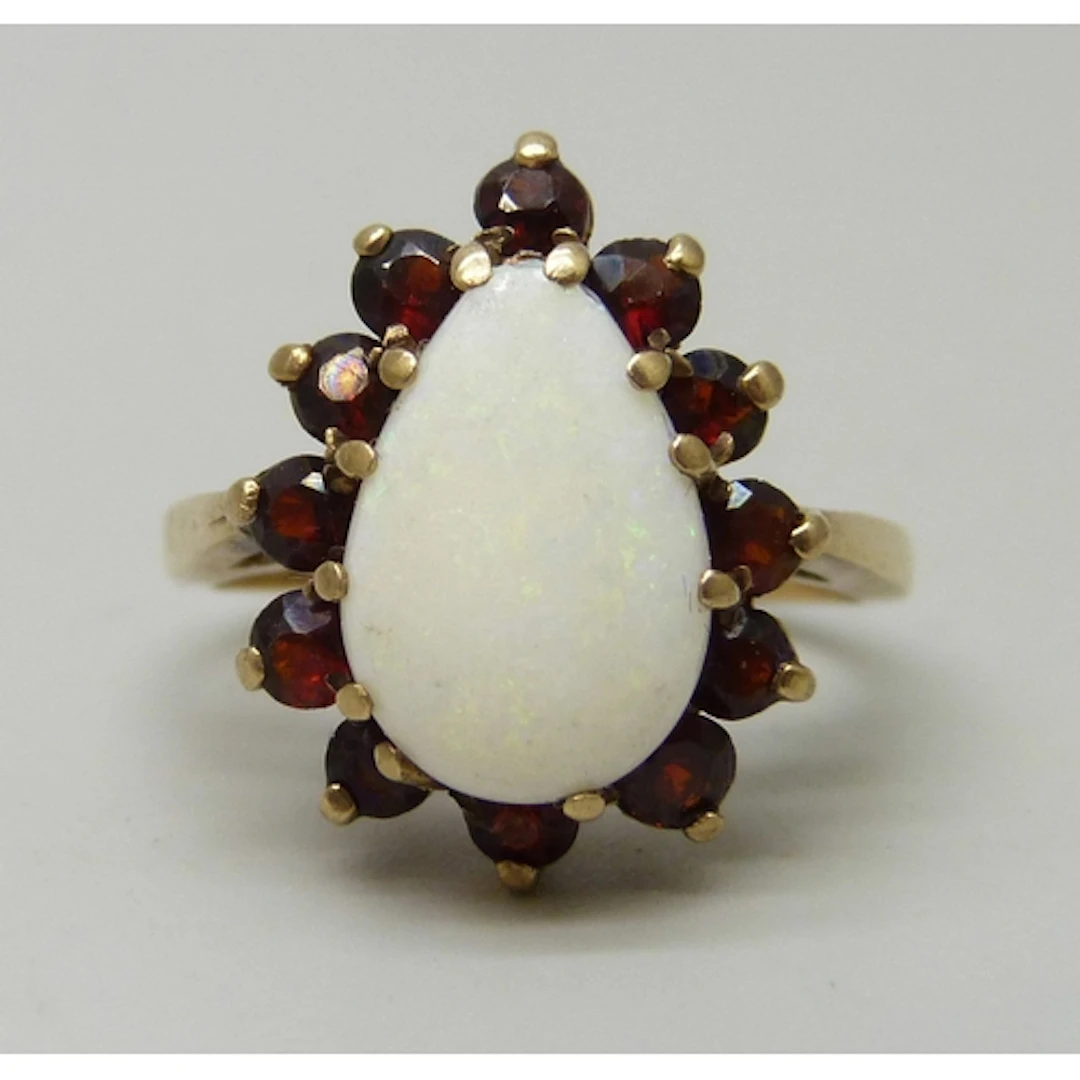 A 9ct gold, opal and garnet ring, some claws a/f and missing...