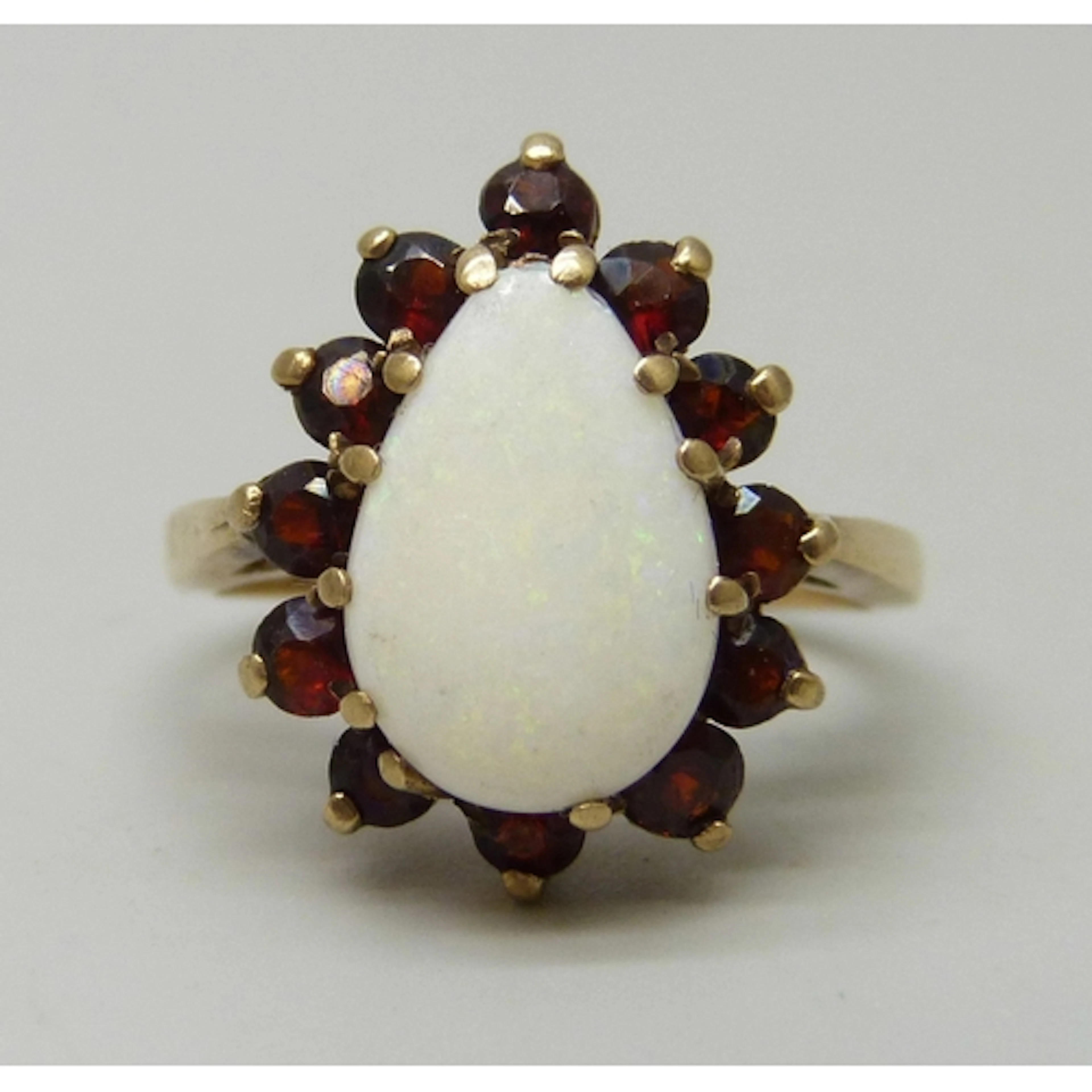 A 9ct gold, opal and garnet ring, some claws a/f and missing...
