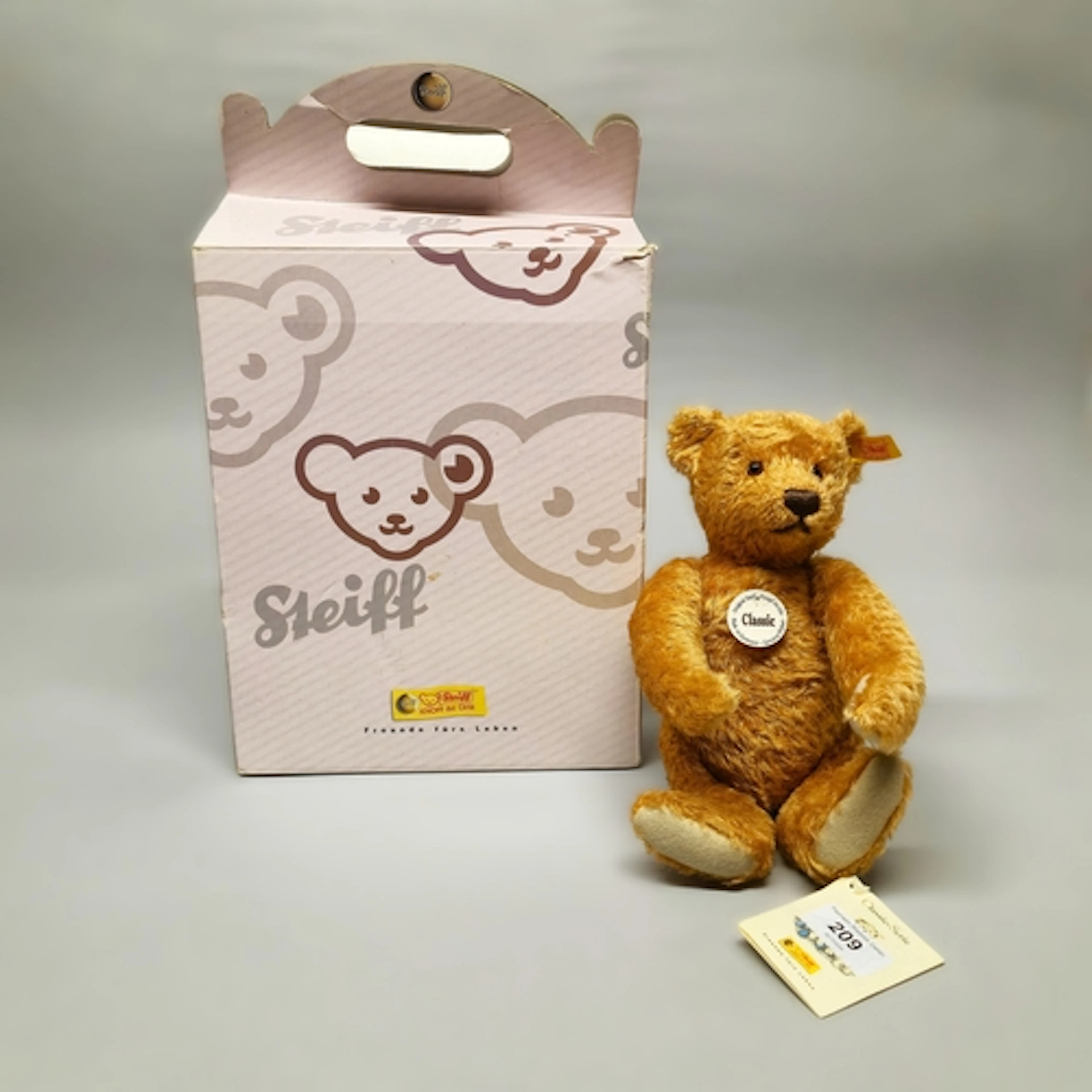 Steiff Classic teddy bear with yellow button tag to left ear...