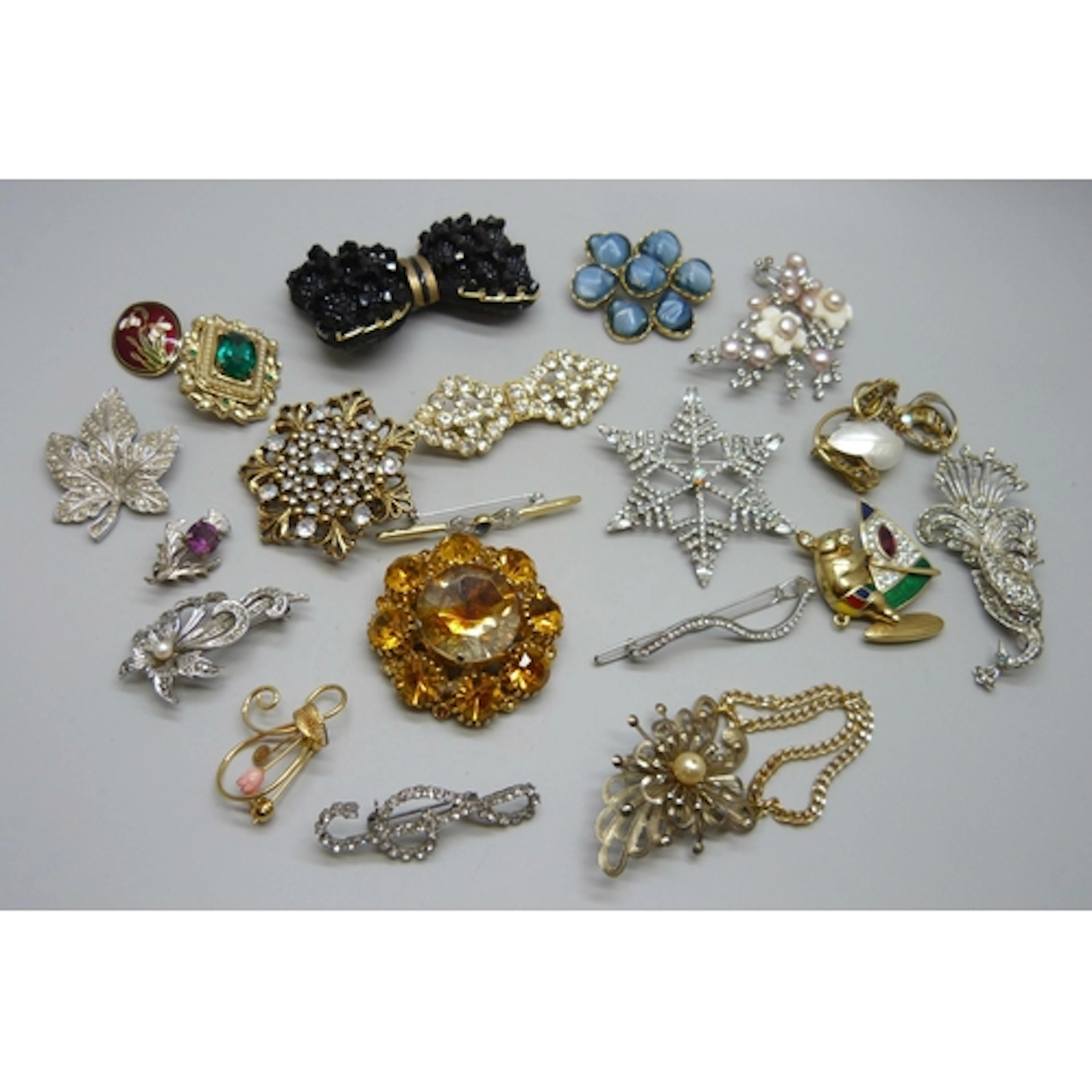 A collection of costume brooches, signed examples including ...