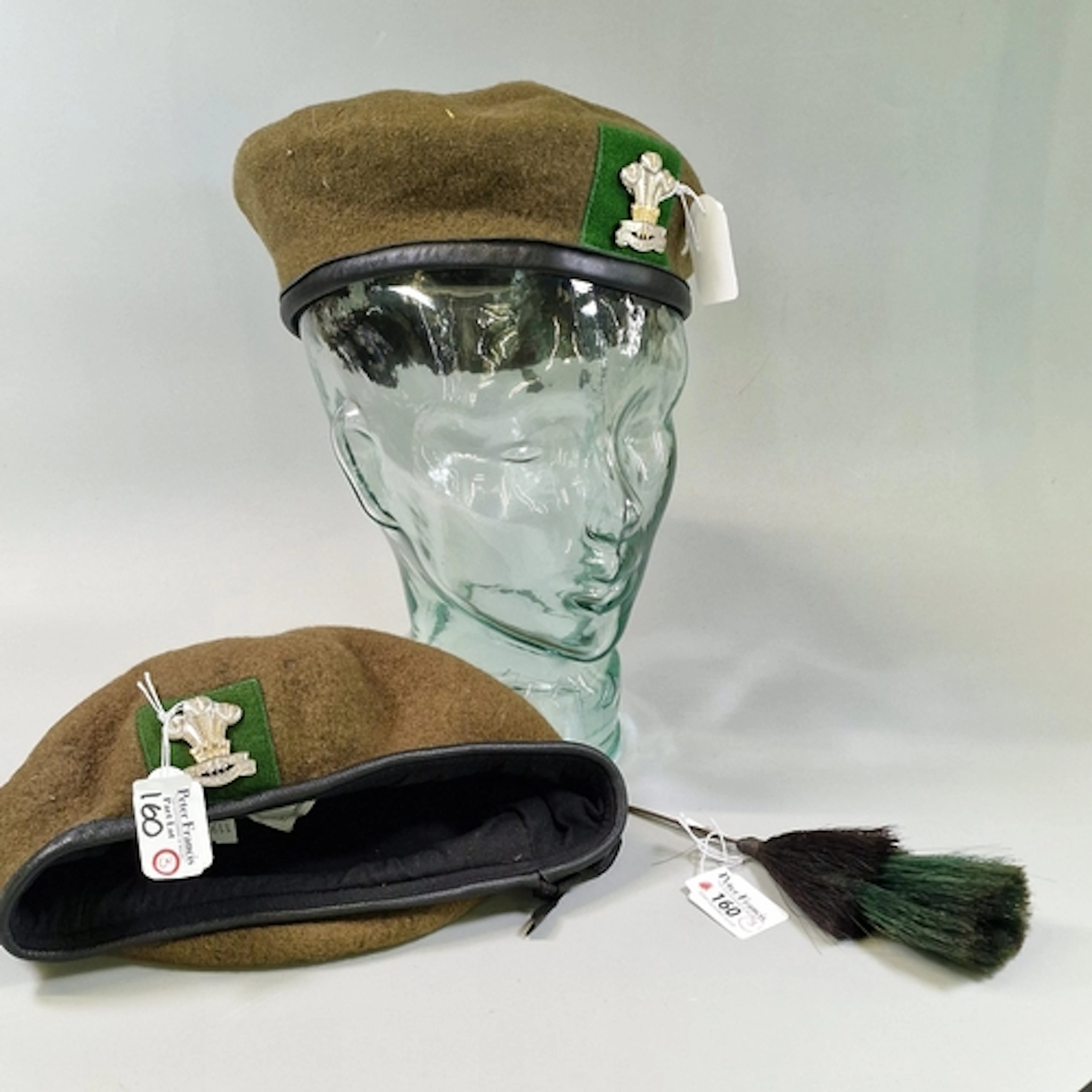Two Royal Welsh green berets with cap badges, together with ...