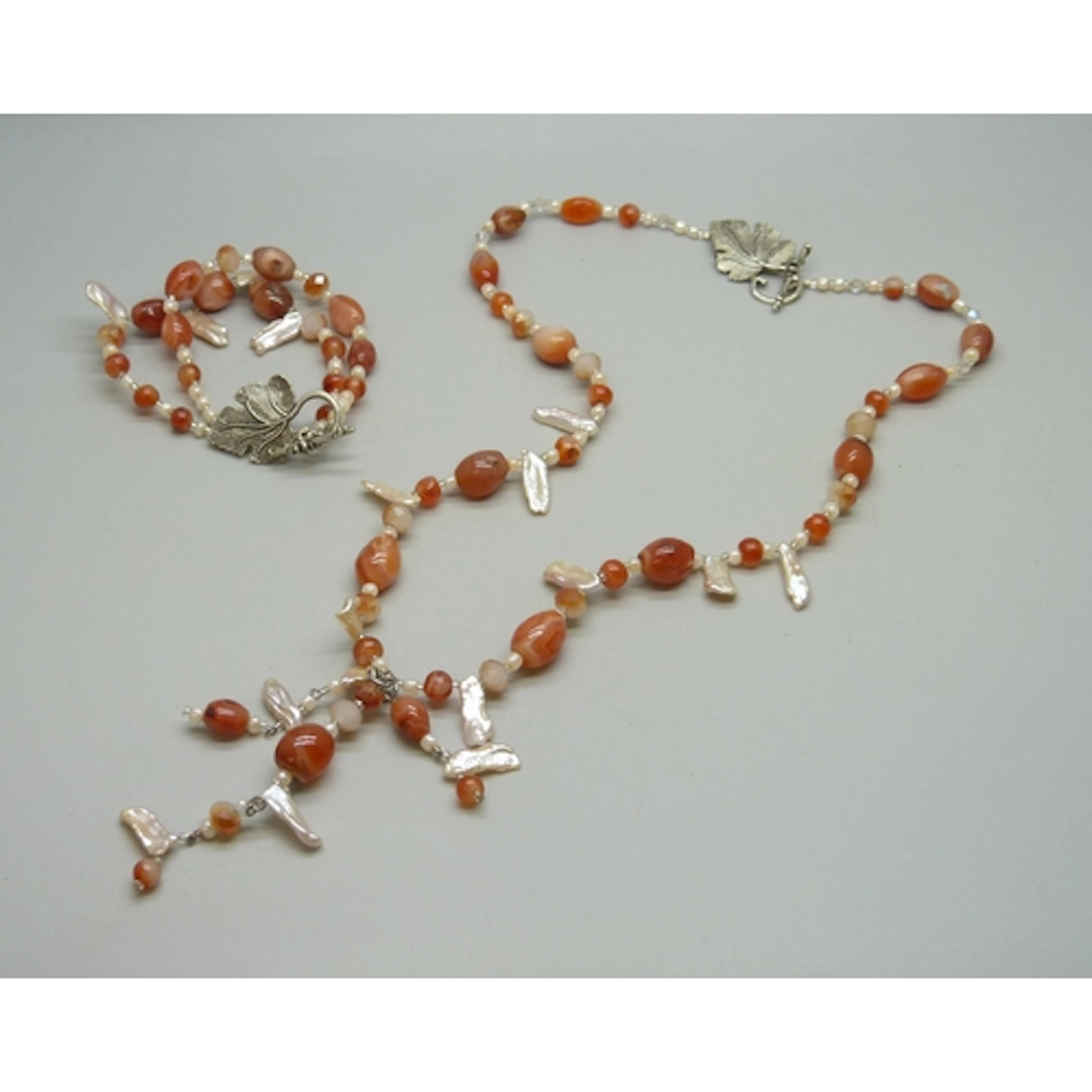 An agate and keshi pearl necklace and bracelet set, both wit...