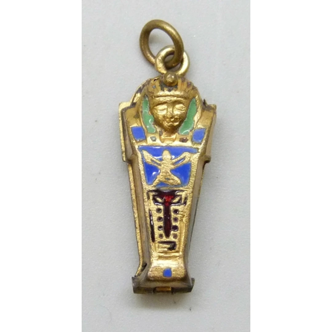 A gilt and enamel Egyptian Revival charm in the form of a sa...