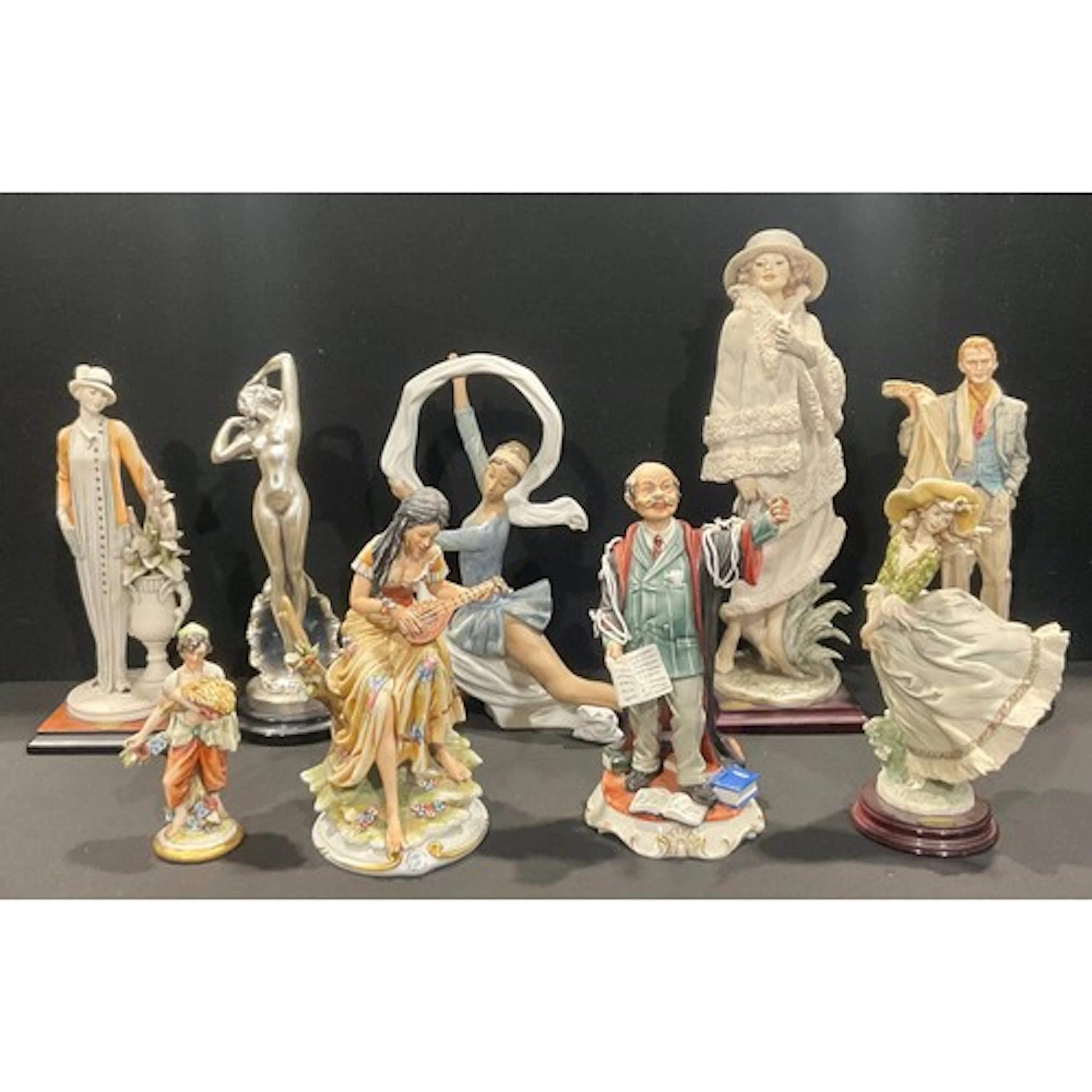 A Nao porcelain figure, of a ballet dancer, 33cm high; a Giu...