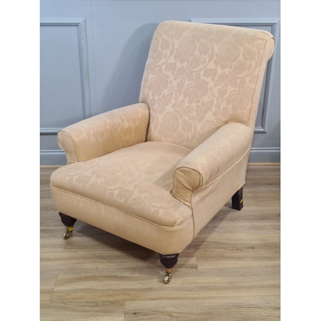 A low seated cream floral upholstered Armchair, (R2).