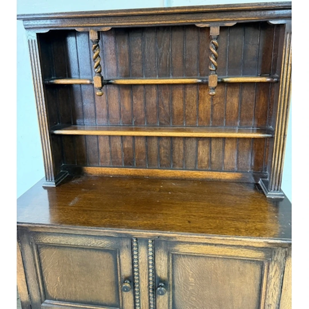 An Oak welsh dresser on barley twist legs and upper plate ra...
