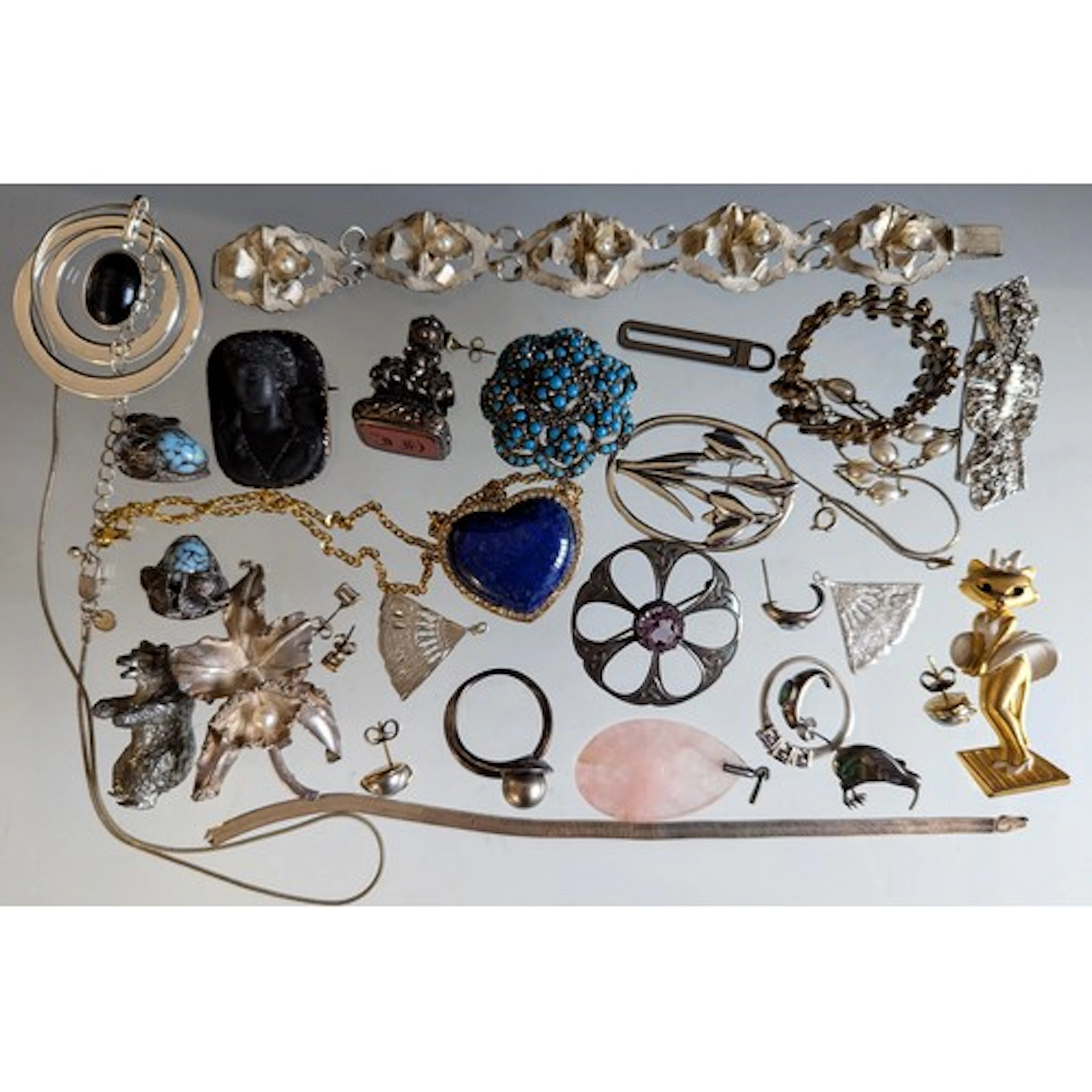 A selection of silver, unmarked white metal and costume jewe...