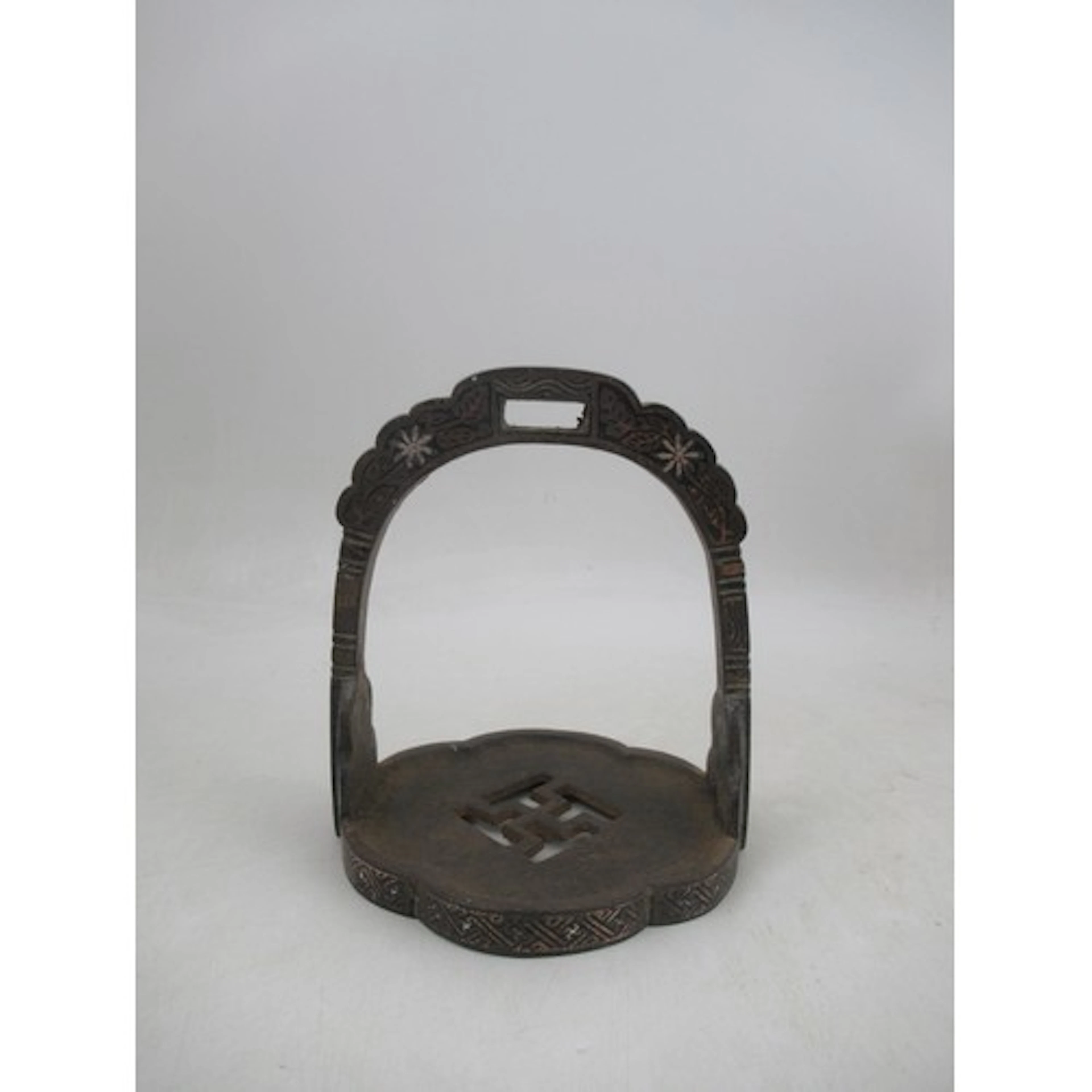 An antique Chinese or Tibetan cast iron stirrup, having all ...