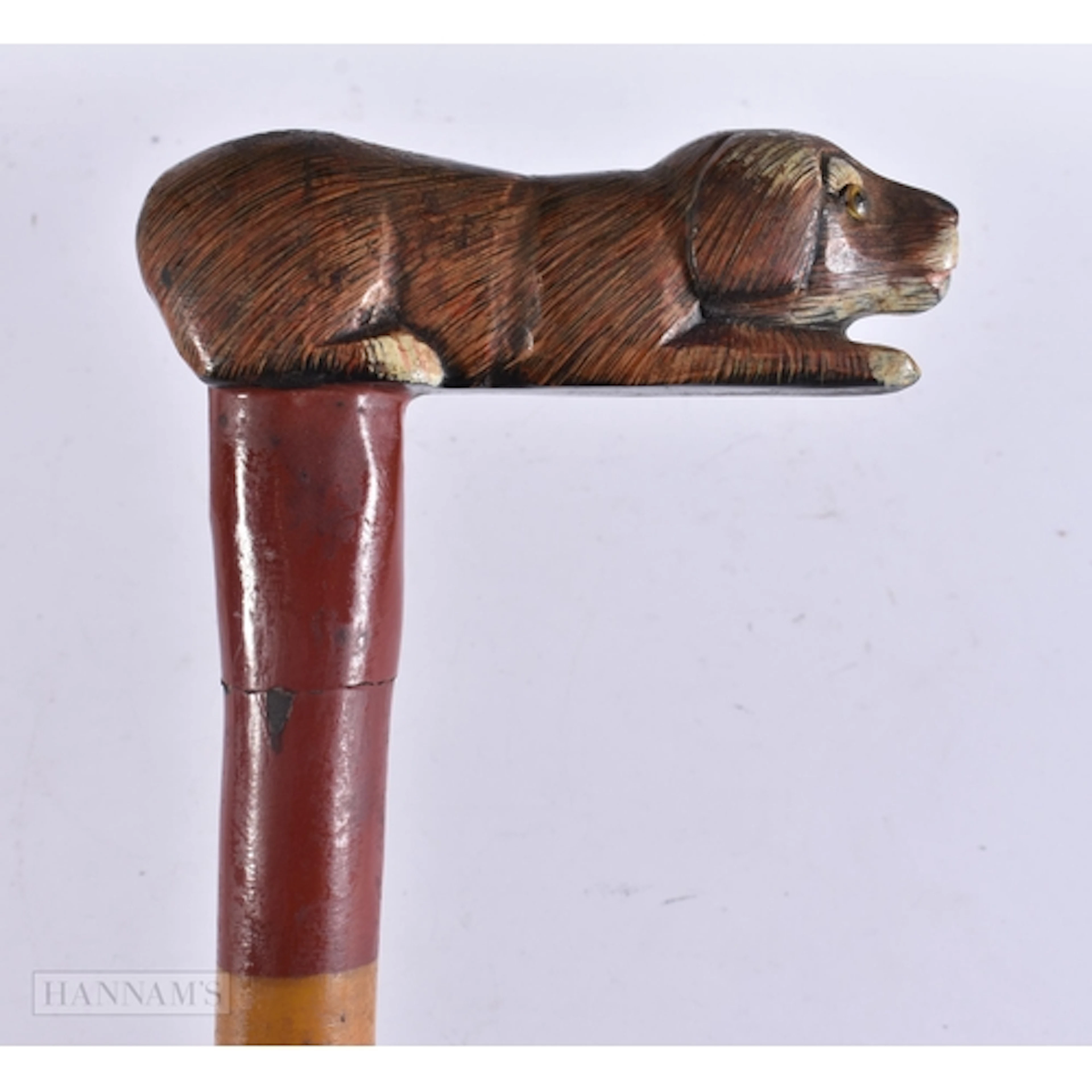 A FOLK ART PAINTED WOOD RECUMBENT HOUND WALKING CANE. 88 cm ...