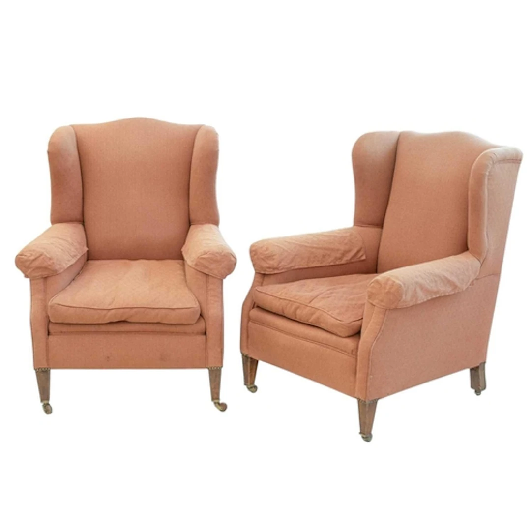 A pair of Edwardian mahogany framed wing armchairs. With pea...