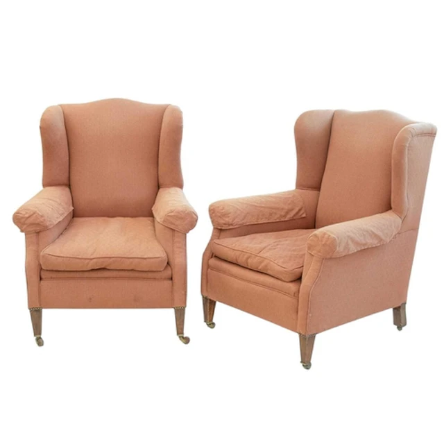 A pair of Edwardian mahogany framed wing armchairs. With pea...