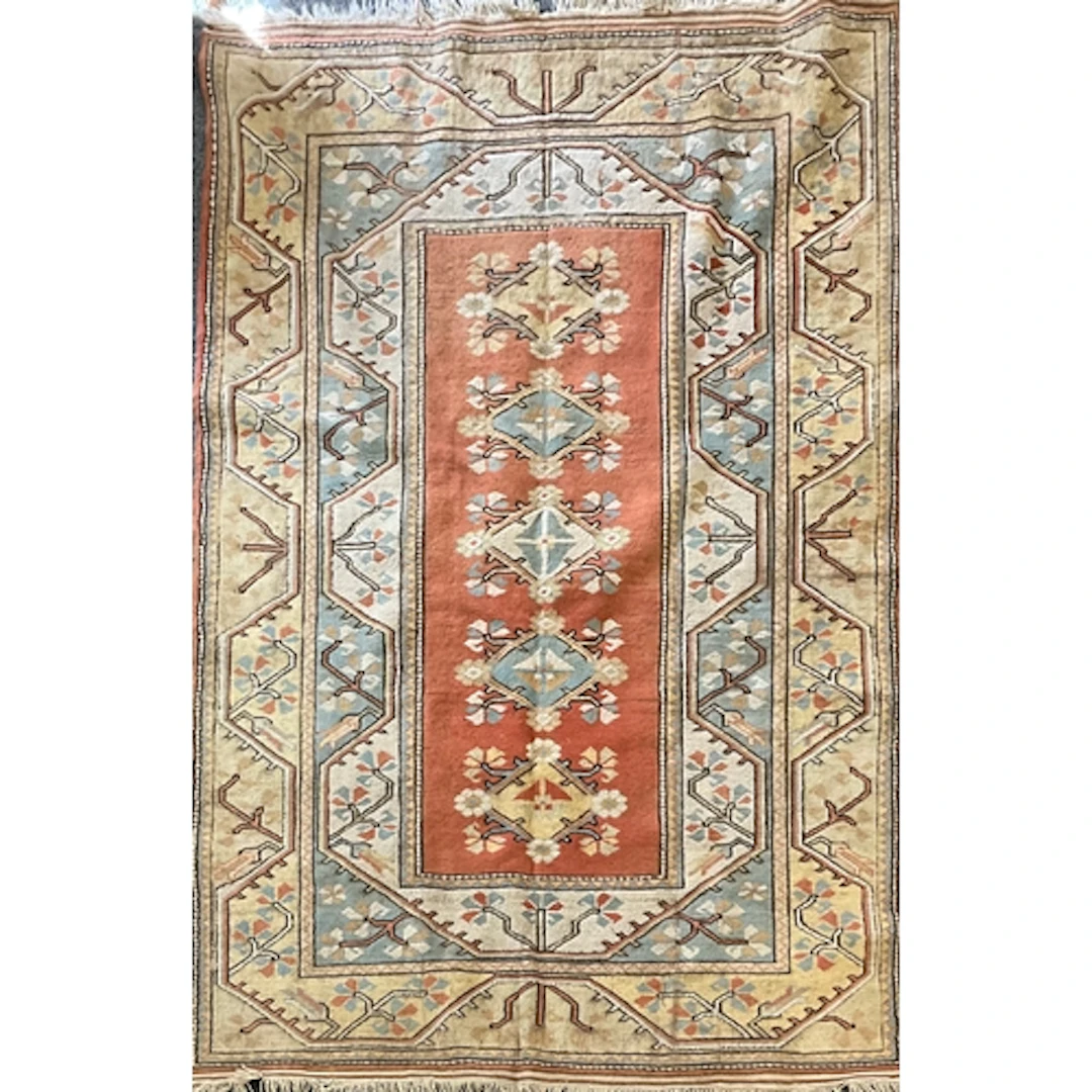 A Persian wool rug, featuring a central rectangular field of...