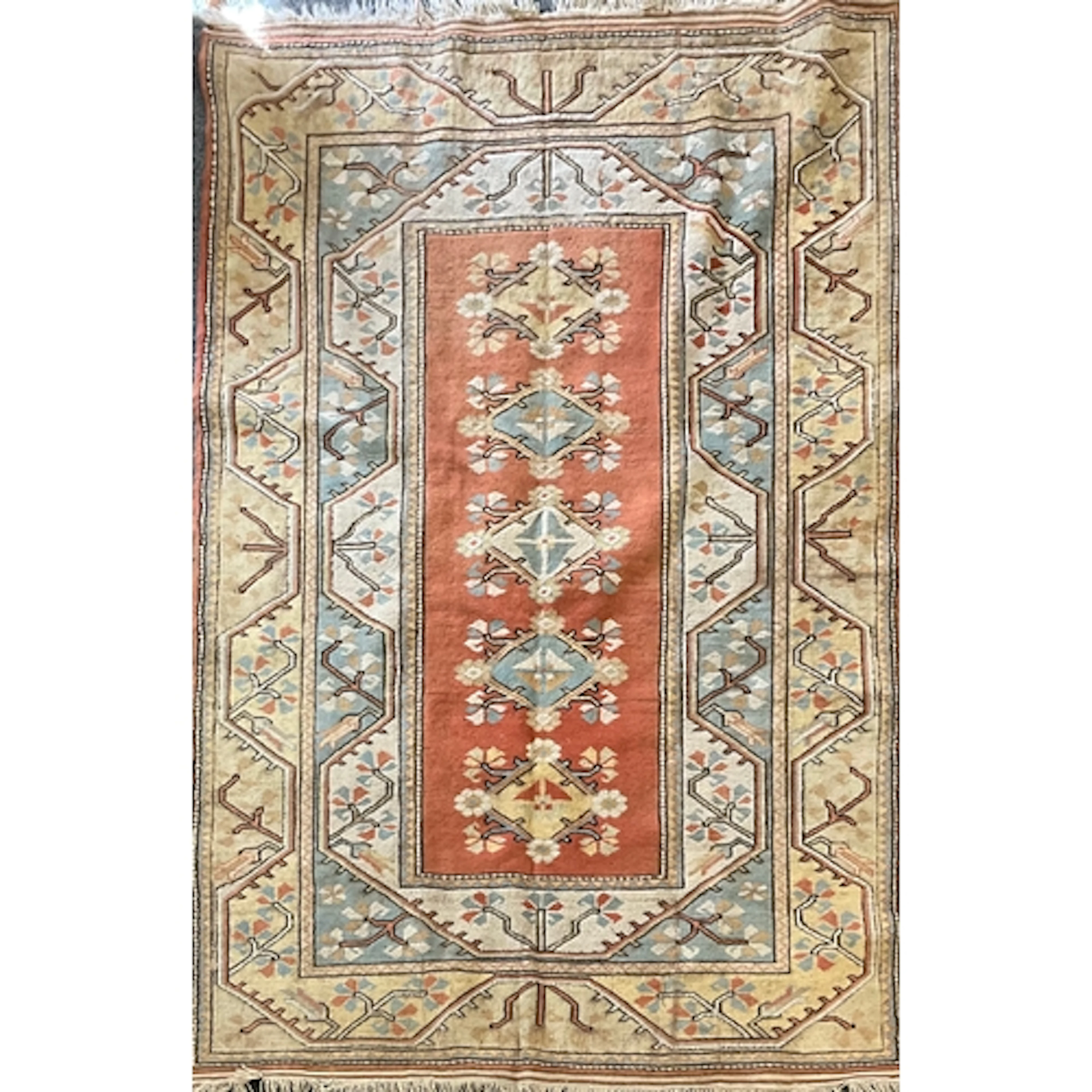A Persian wool rug, featuring a central rectangular field of...
