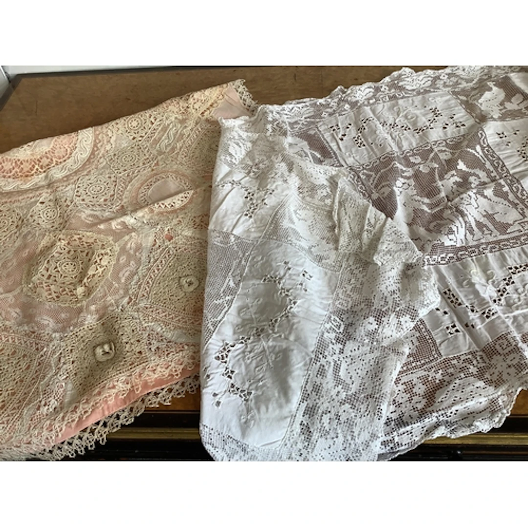 A 1920's Normandy lace pillow sham with pink silk lining and...