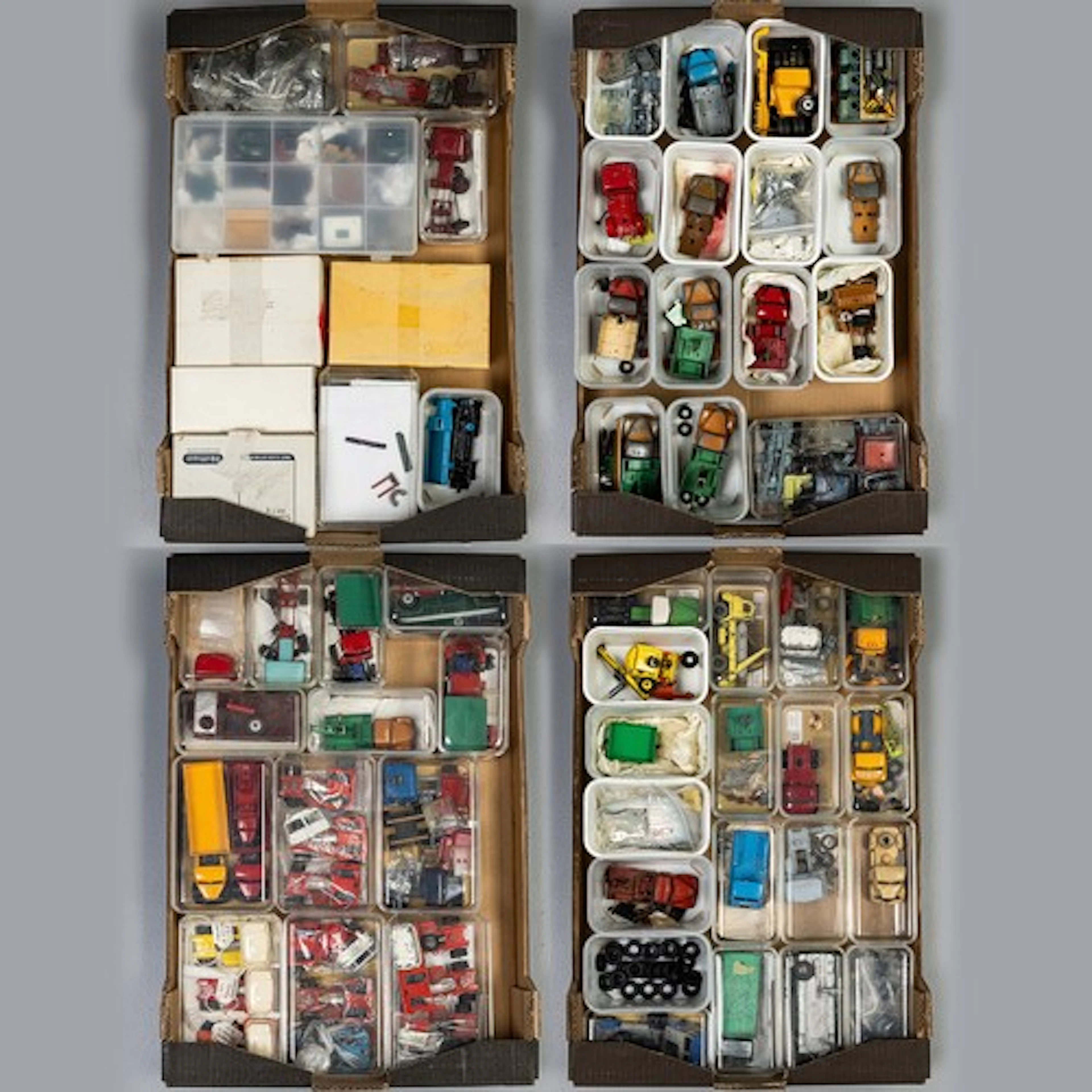 Four fruit trays containing 57 plastic boxes/cartons each on...