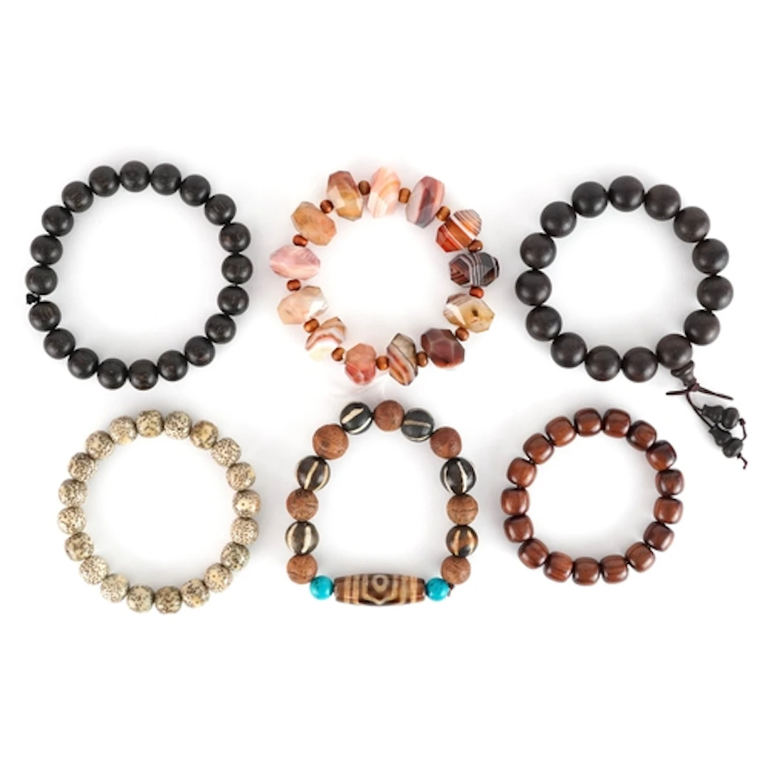 Six beaded bracelets including one with a dzi bead flanked b...