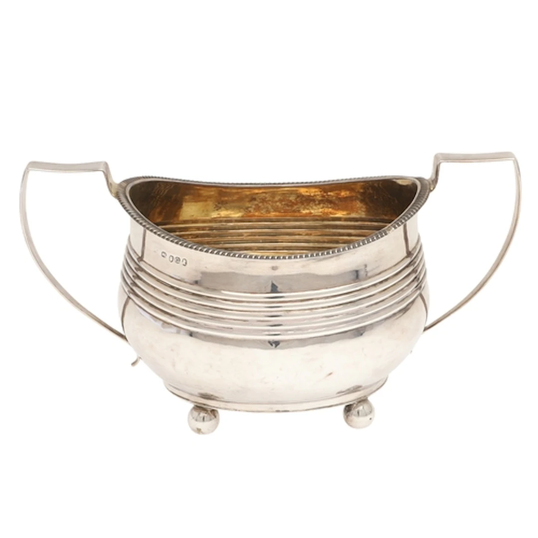 A GEORGE III SILVER SUGAR BASIN. With twin handles and gilde...
