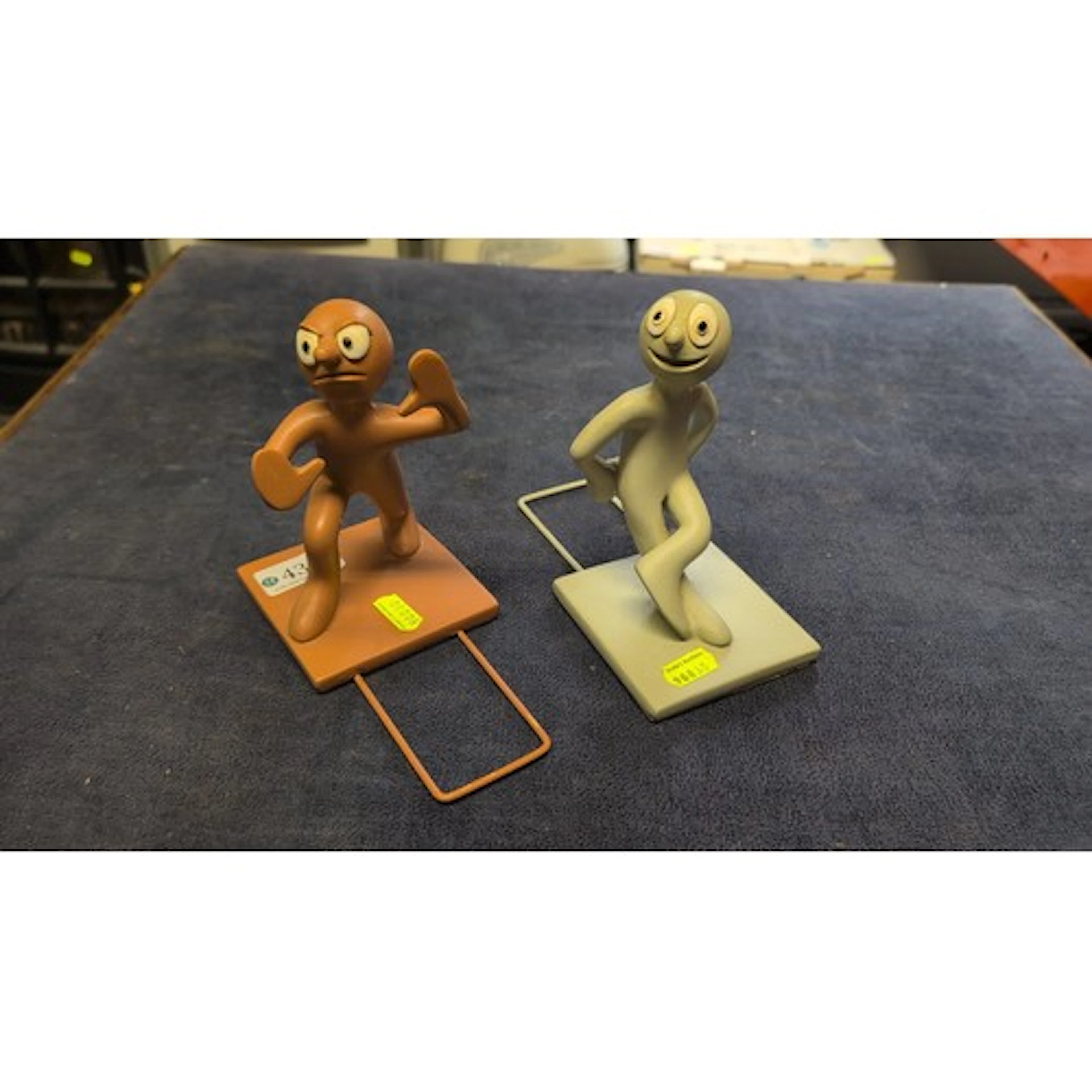 A pair of painted moulded plastic cartoon character figural ...