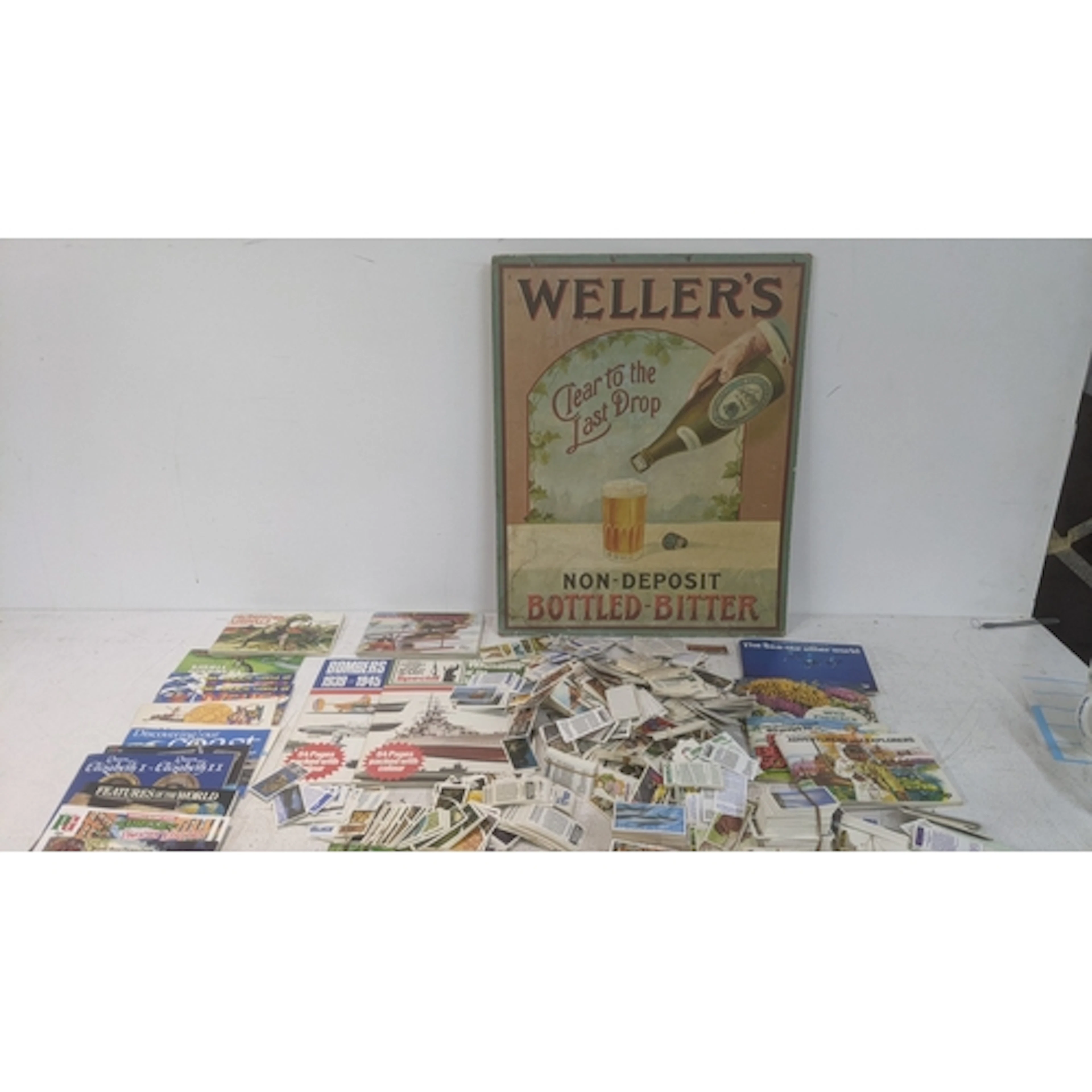 A collection of tea cards, some in albums, some loose, along...