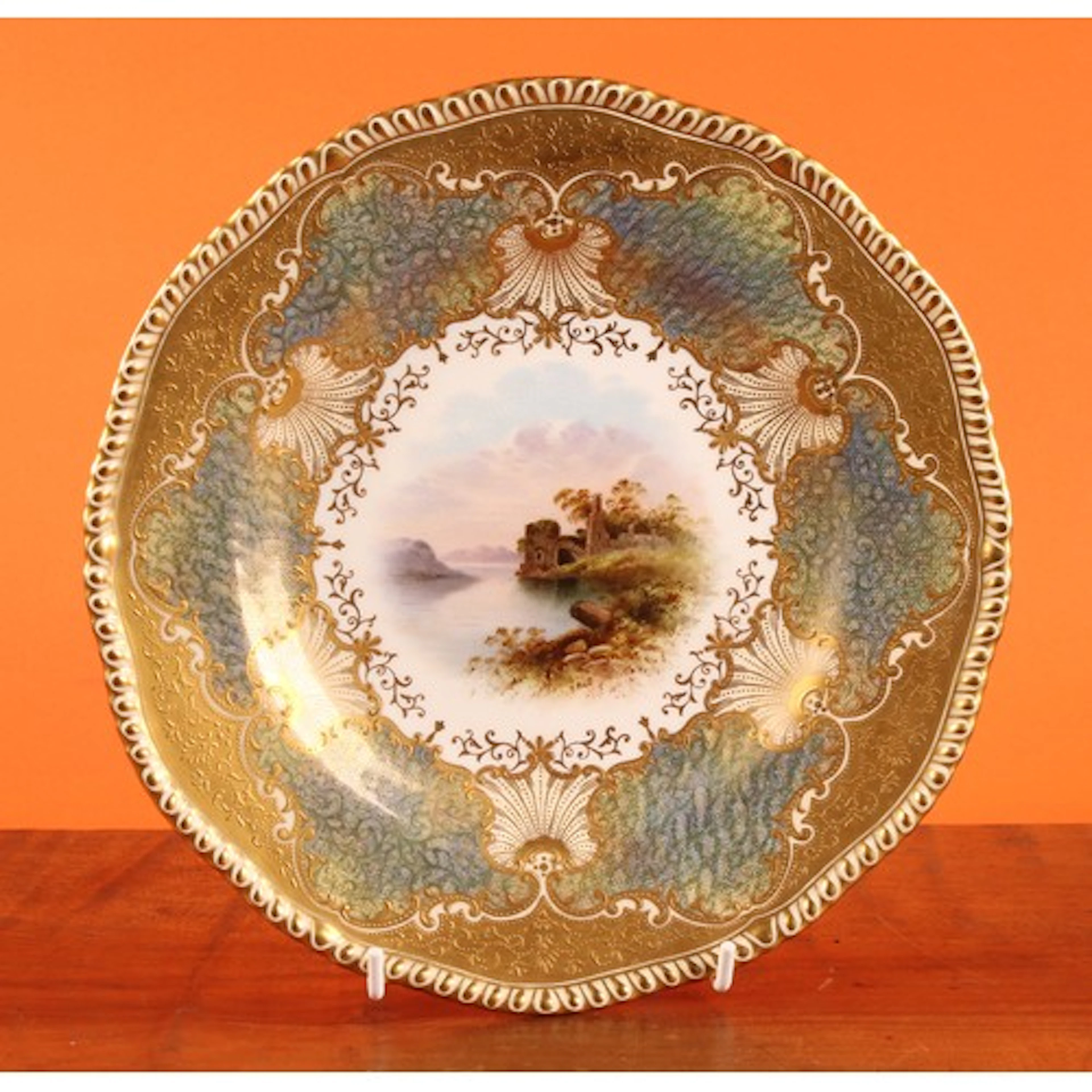 A Coalport shaped circular cabinet plate, painted by Edward ...