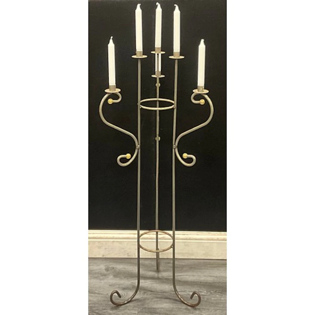 A floor standing six light three arm tubular iron candelabra...