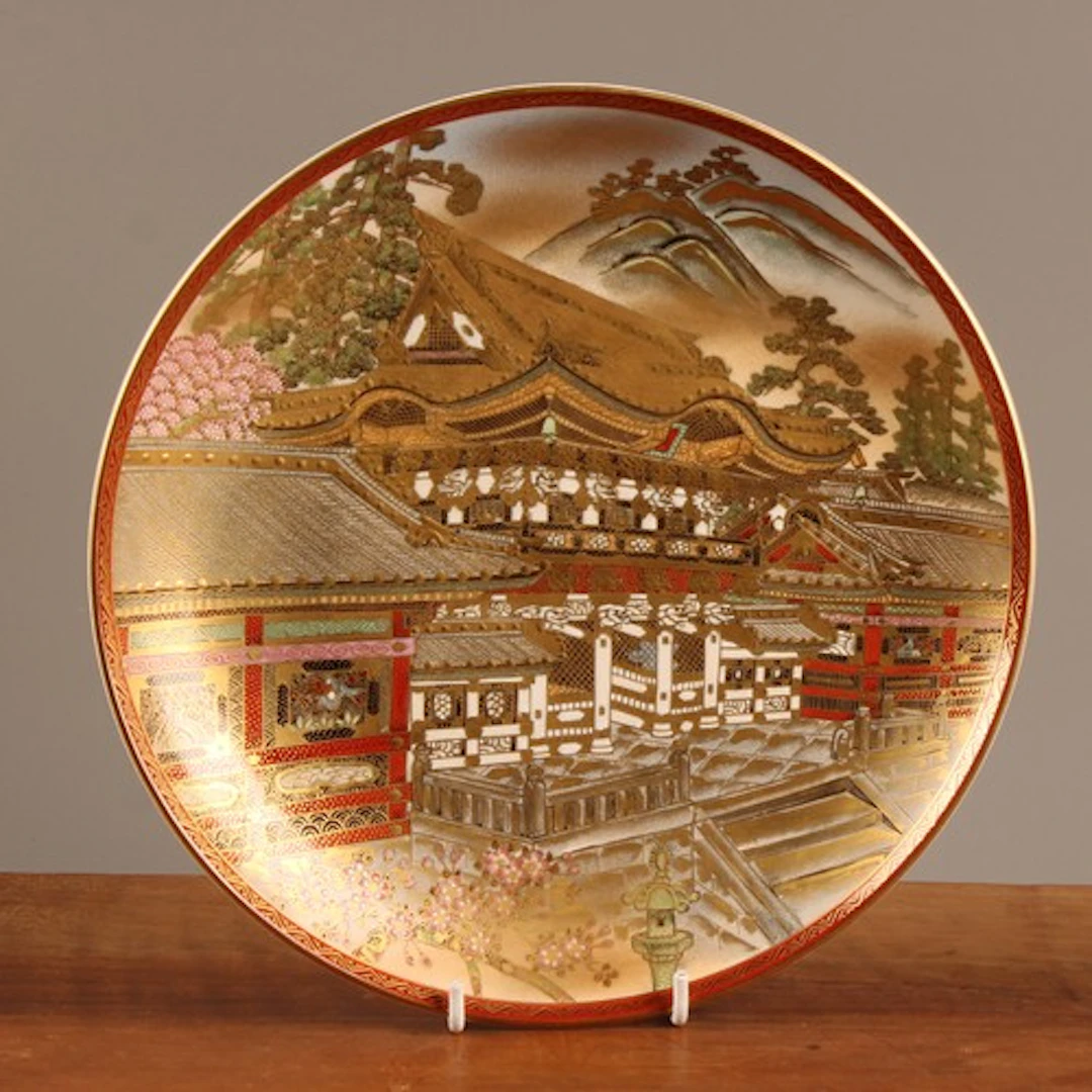A Japanese Satsuma circular dish, typically painted and gild...