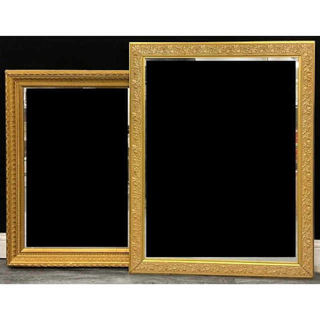 A giltwood rectangular looking glass, the frame with borders...