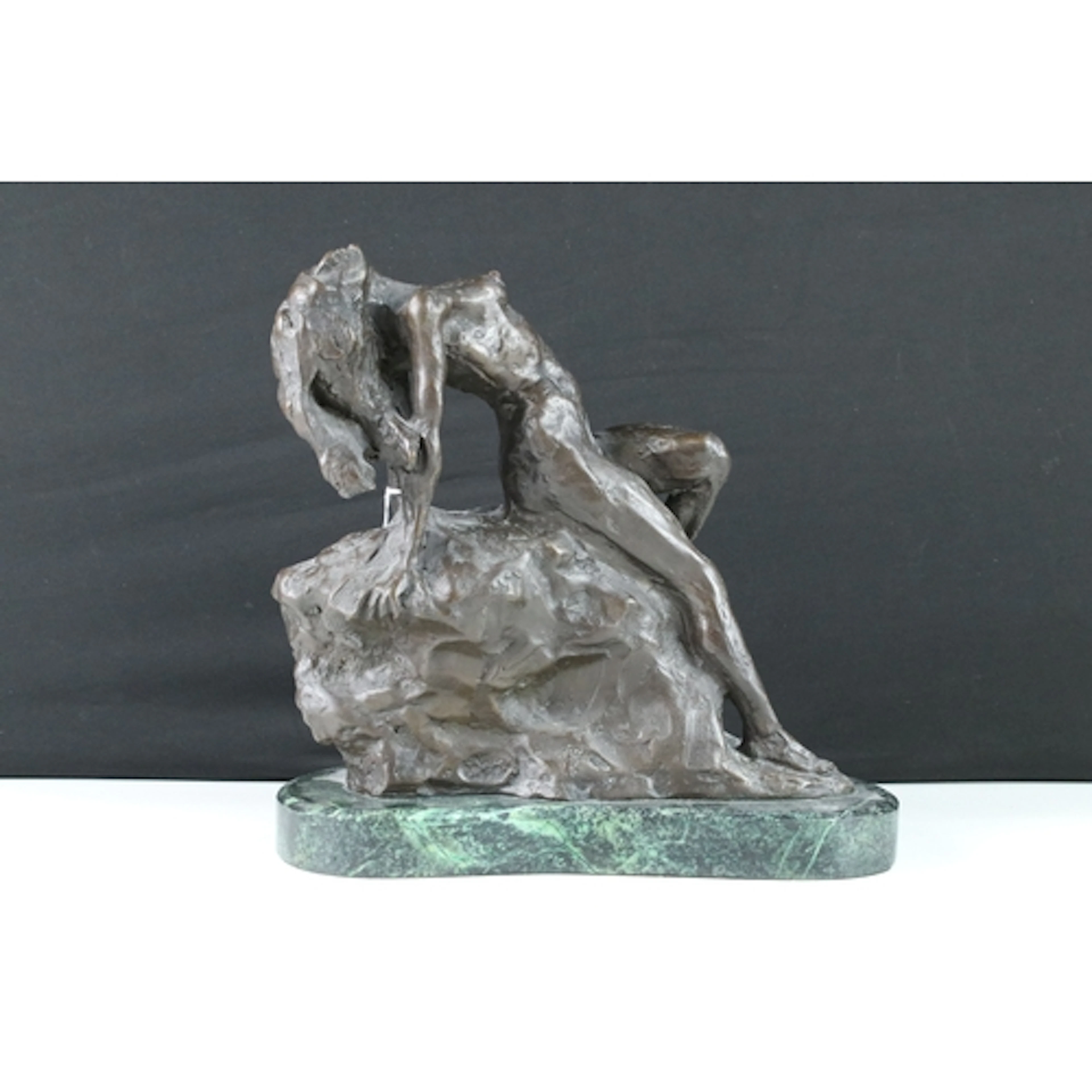Art Deco style bronze model of a female nude reclining on a ...