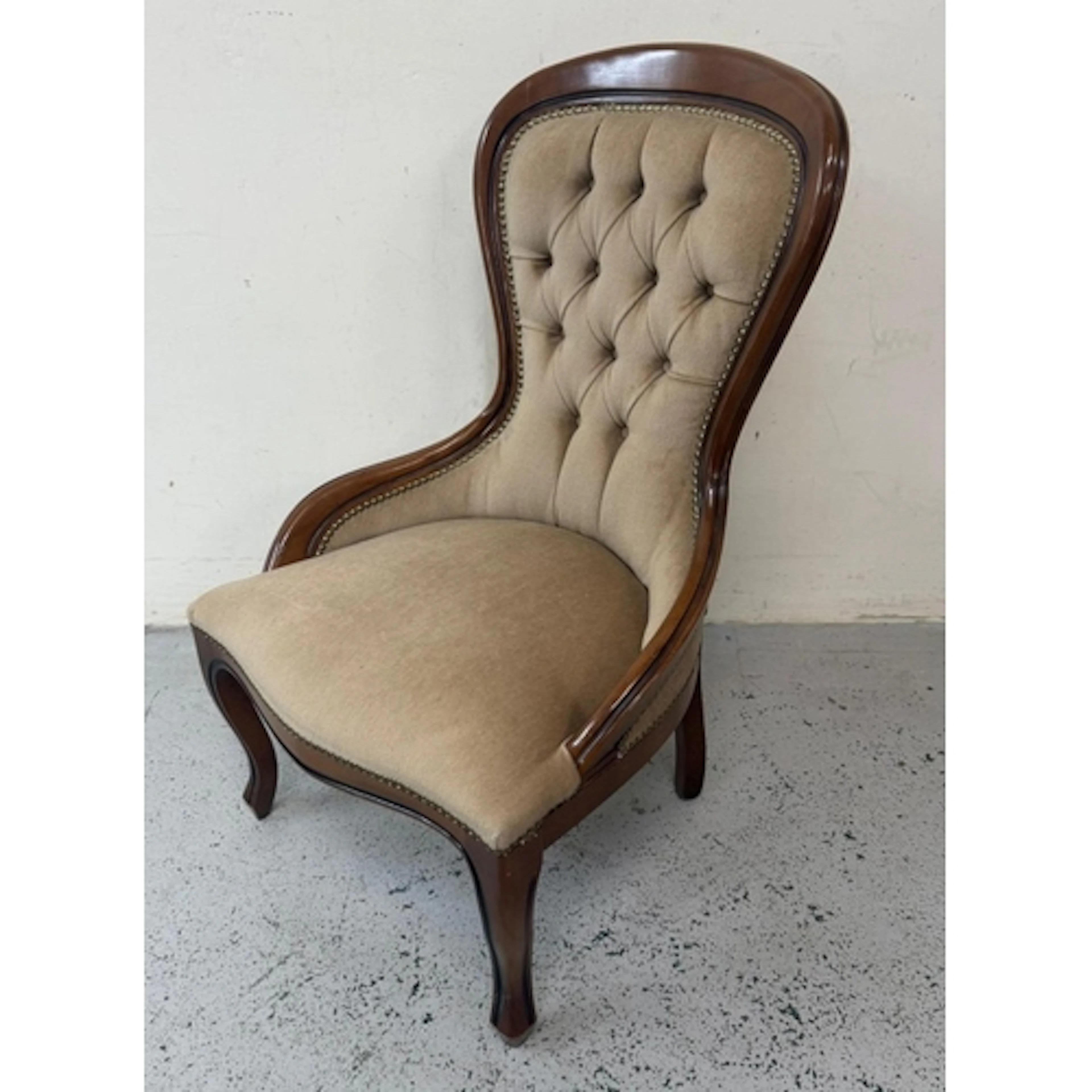 A mahogany spoon back bedroom chair in beige