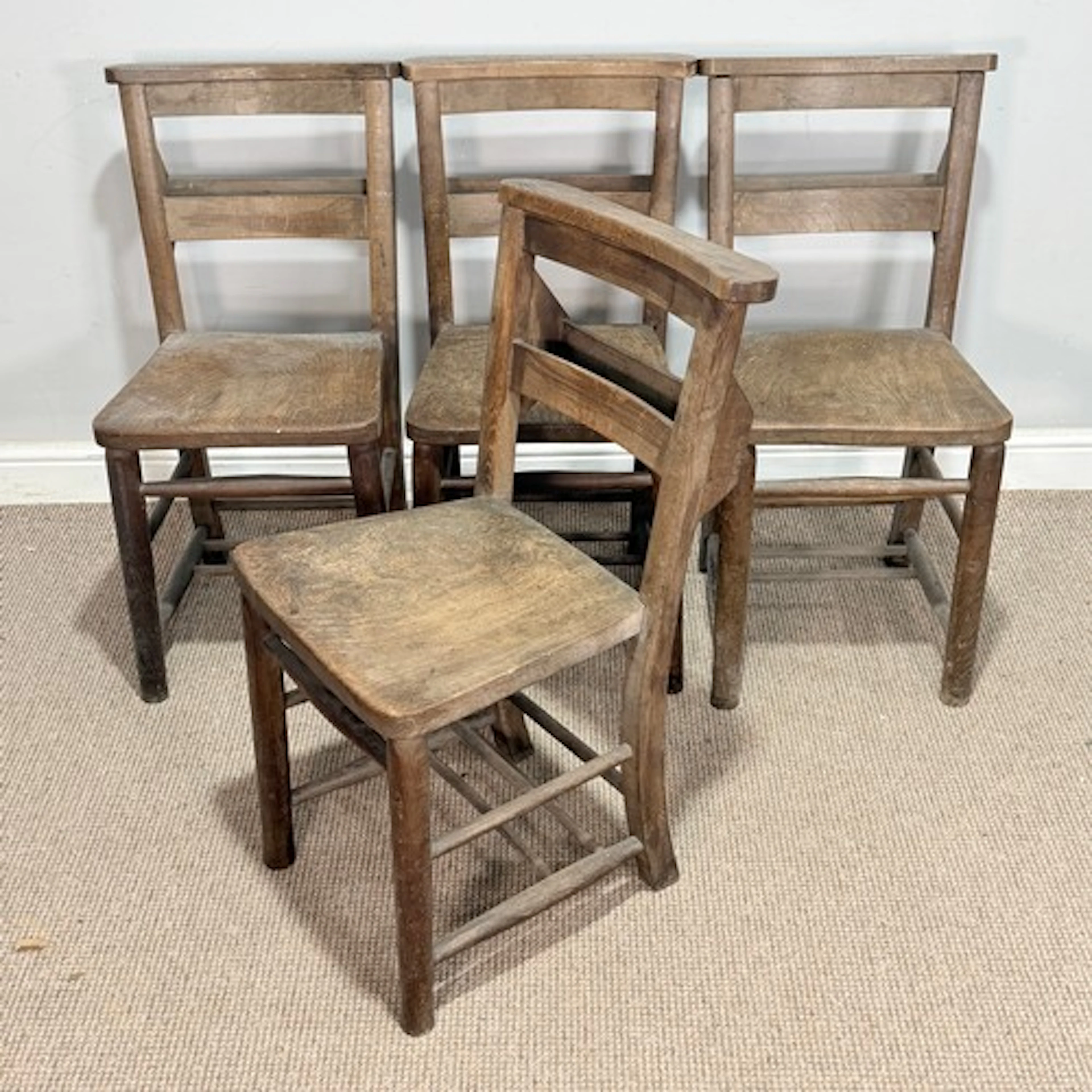 A set of four antique elm Chapel Chairs, with a bible tray t...