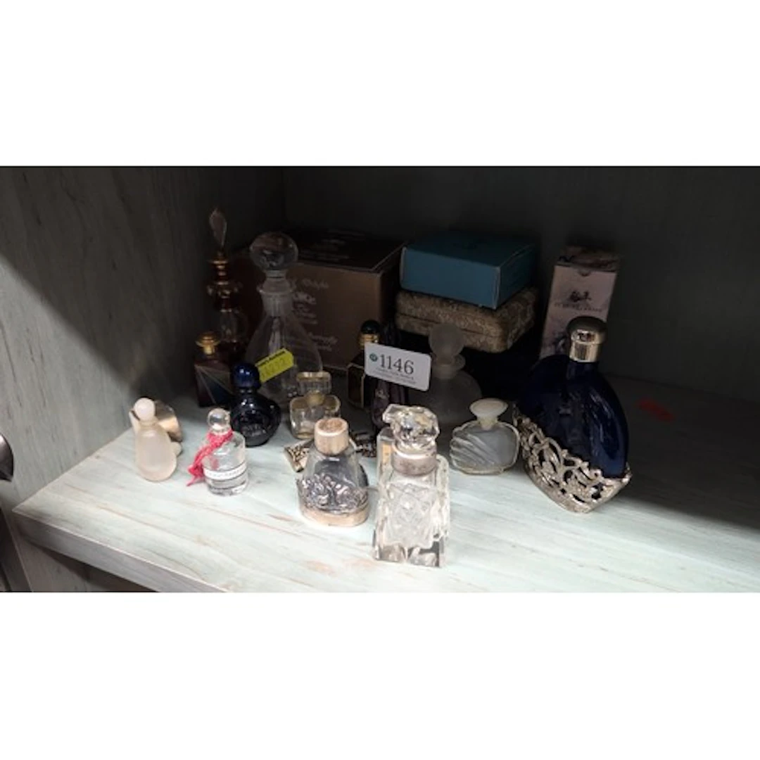 A collection of glass perfume and scent bottles, including C...